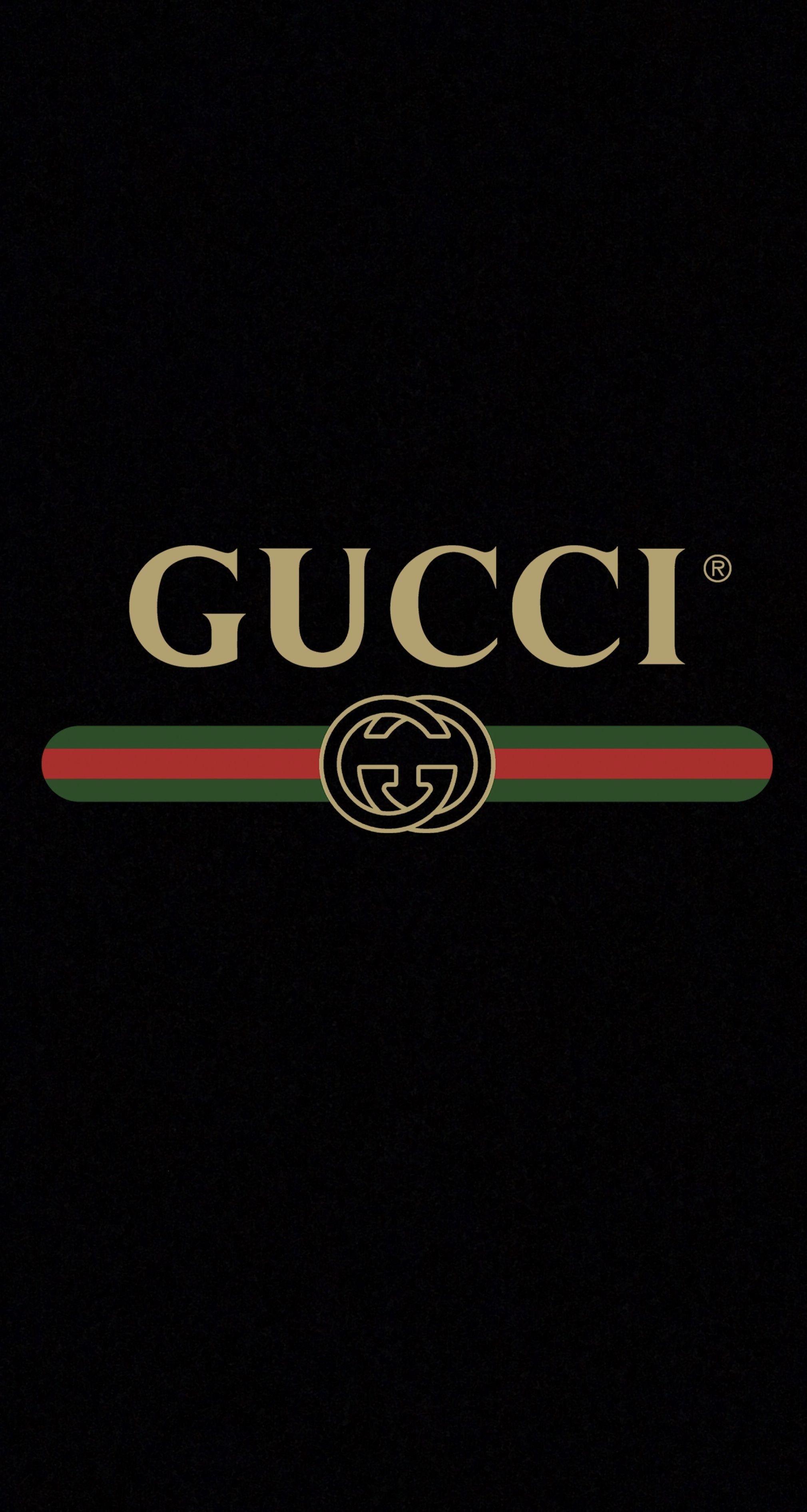 IPhone wallpaper of the gucci logo in gold with a black background - Gucci