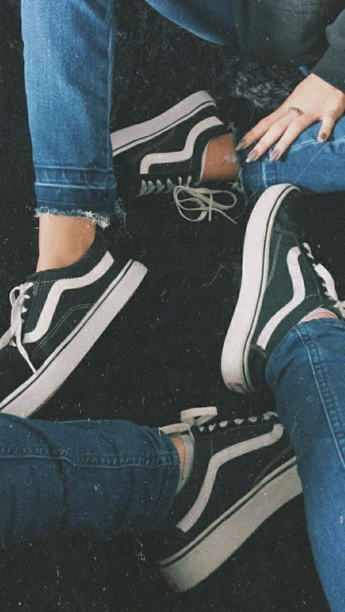 Black and white vans shoes, worn by two people, sitting on the floor, wearing ripped jeans, cool backgrounds - Converse, shoes