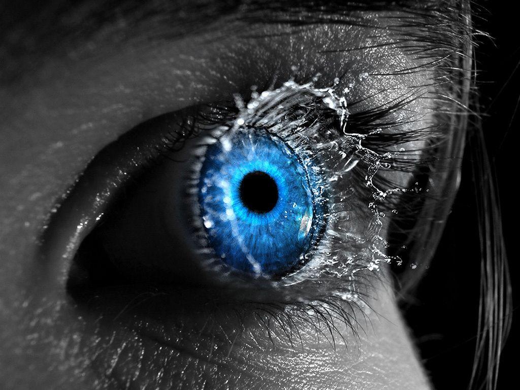 A blue eye with water droplets around it - Eyes