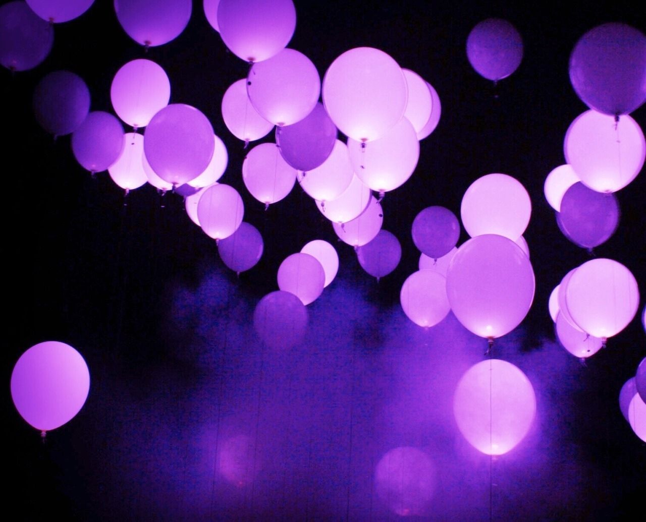 Many purple balloons floating in the air. - Balloons