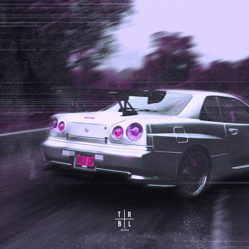 A car is driving down a road with trees in the background. - Nissan Skyline