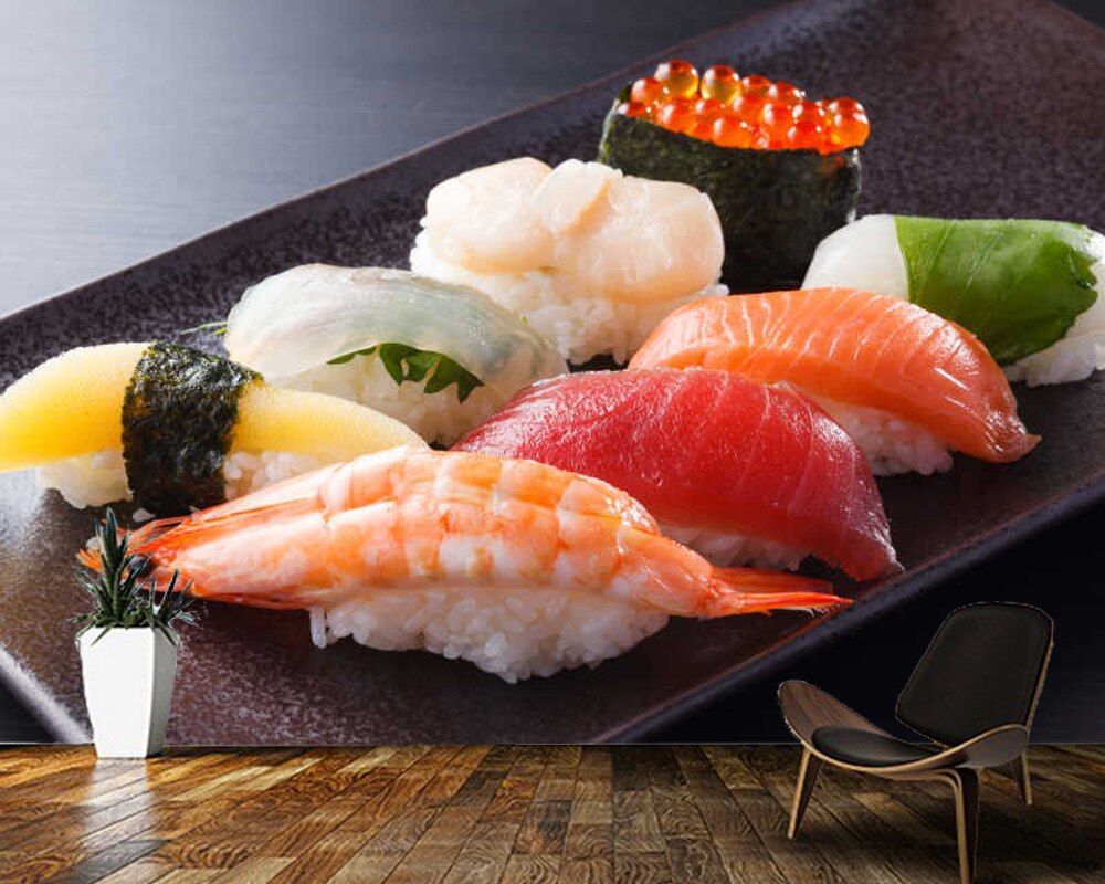 A plate of assorted sushi with various fish and rice - Sushi