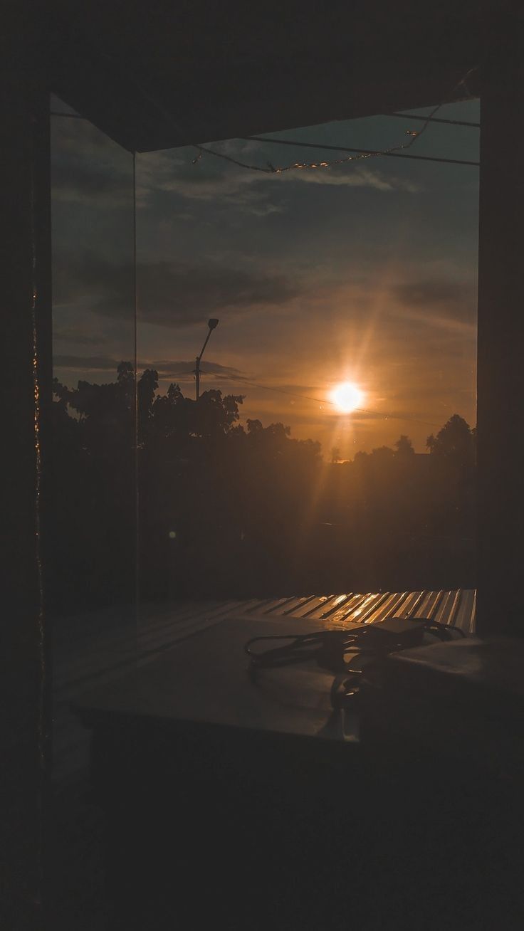 Sunset through the window of a bus stop in the city - Sunlight, sunshine