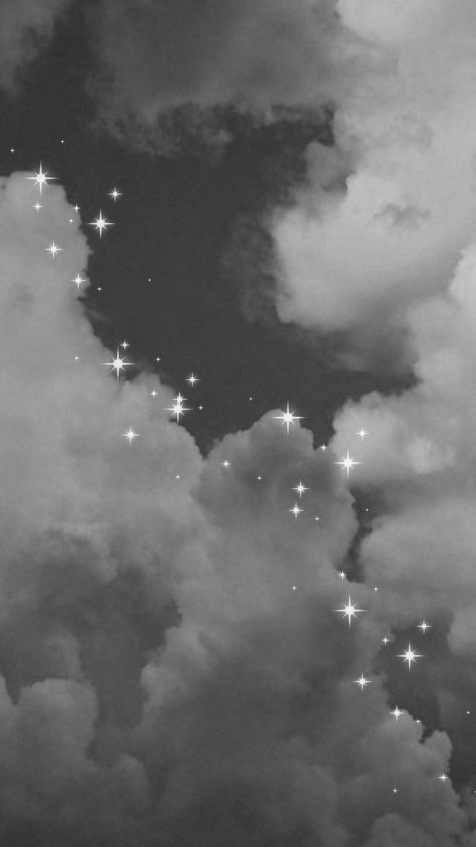 A black and white photo of clouds with stars - Gray