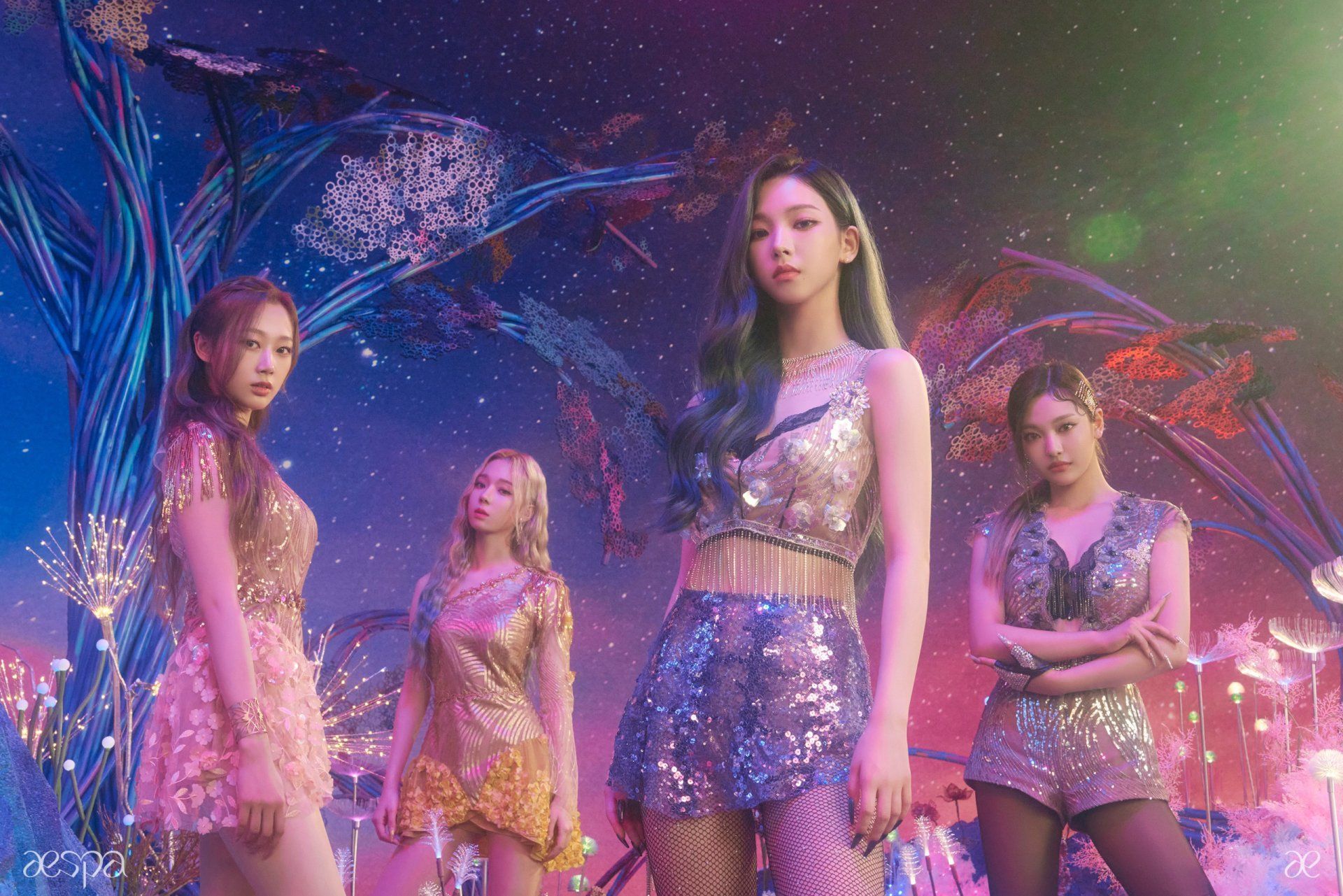The members of ITZY, a K-Pop group, stand in front of a colorful background. - Aespa