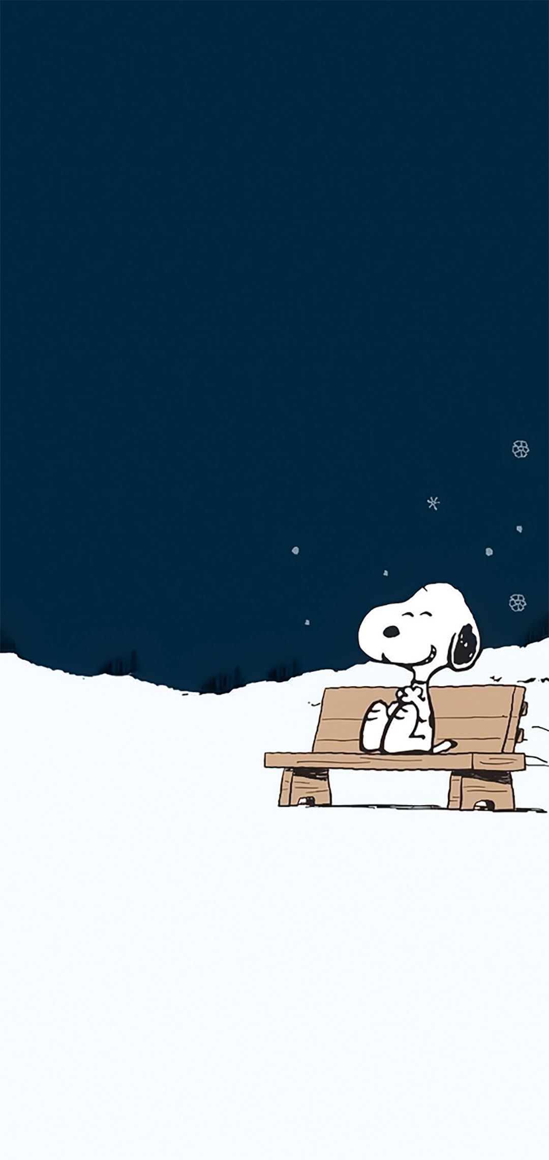 Snoopy sitting on a bench in the snow - Charlie Brown