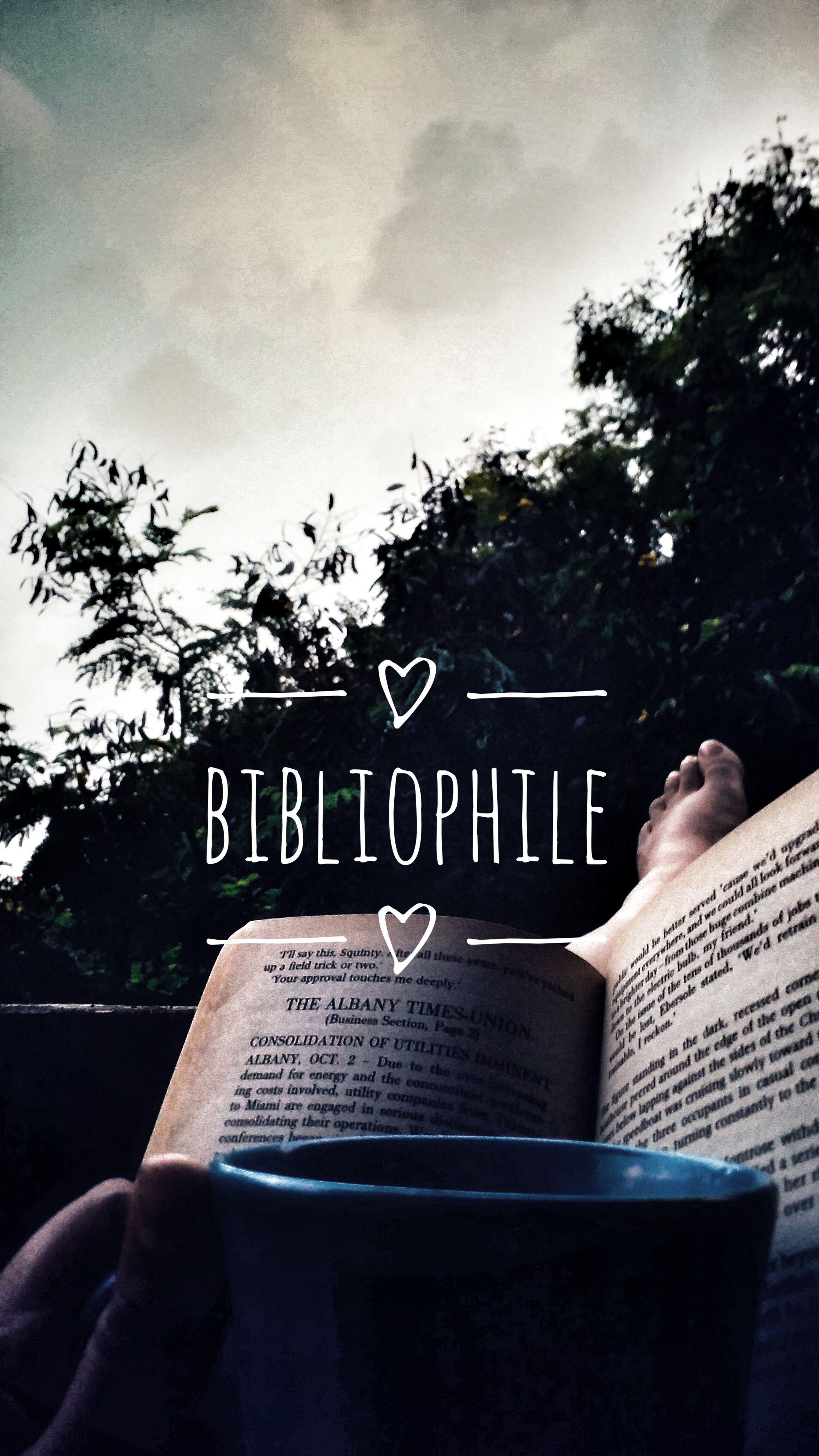 A person reading a book outside with the word Bibliophile written over the top - Books, Miami