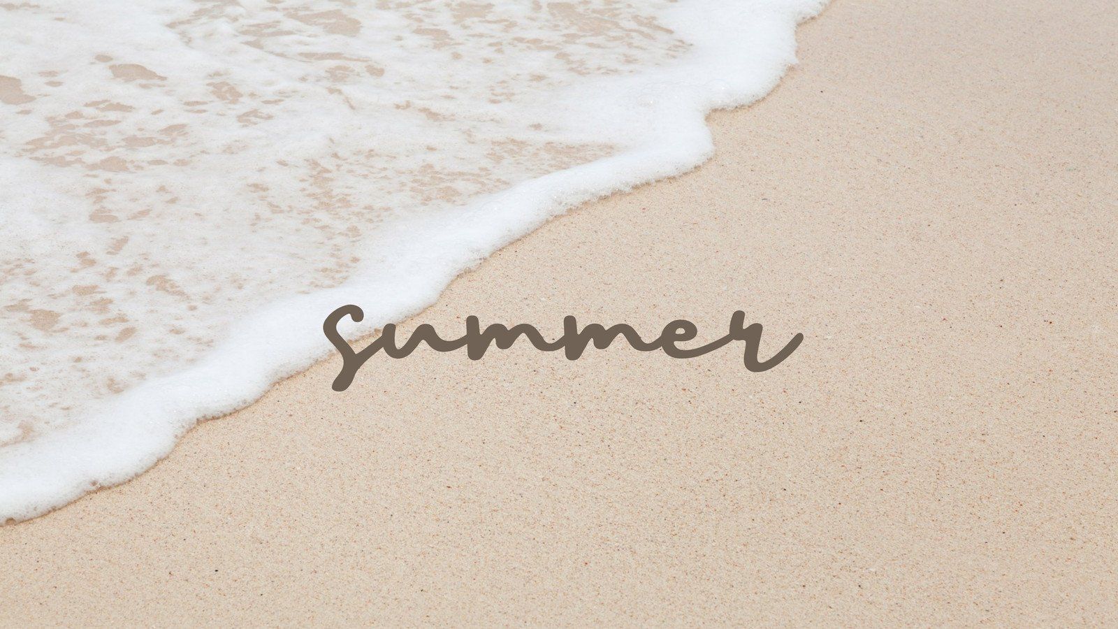 The word summer written in the sand on a beach with the ocean coming up. - Summer, coast