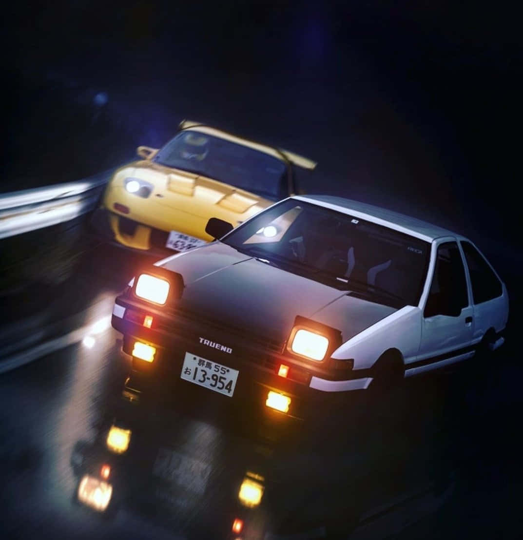 A white Toyota Trueno and a yellow Toyota Supra race down a wet road at night. - Toyota AE86