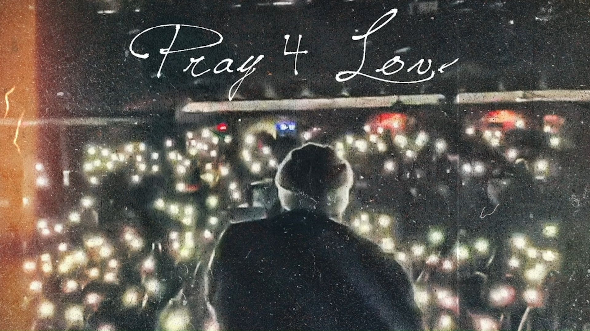 A man standing in front of a crowd with the words Pray 4 Love written above him - Rod Wave