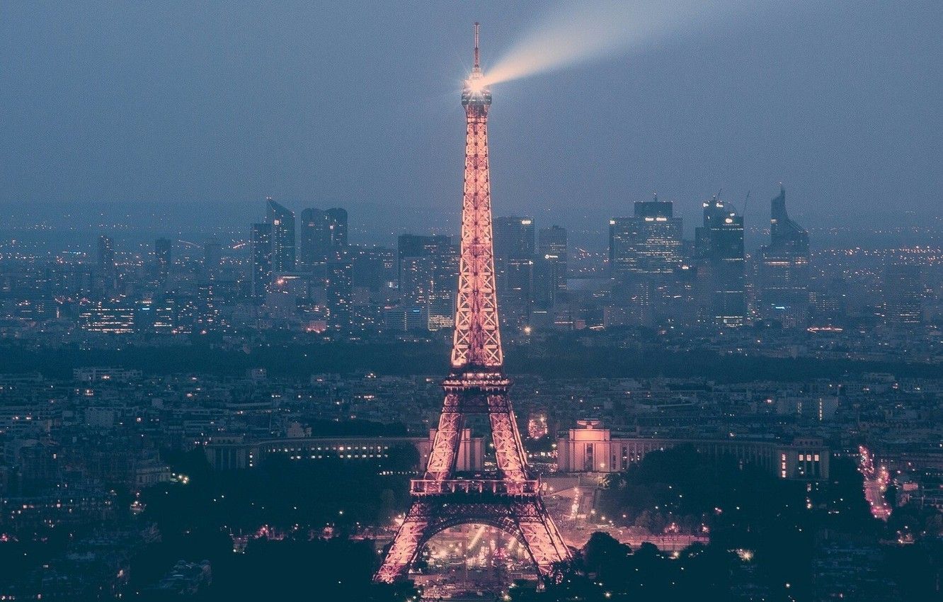 The eiffel tower is lit up at night - Eiffel Tower