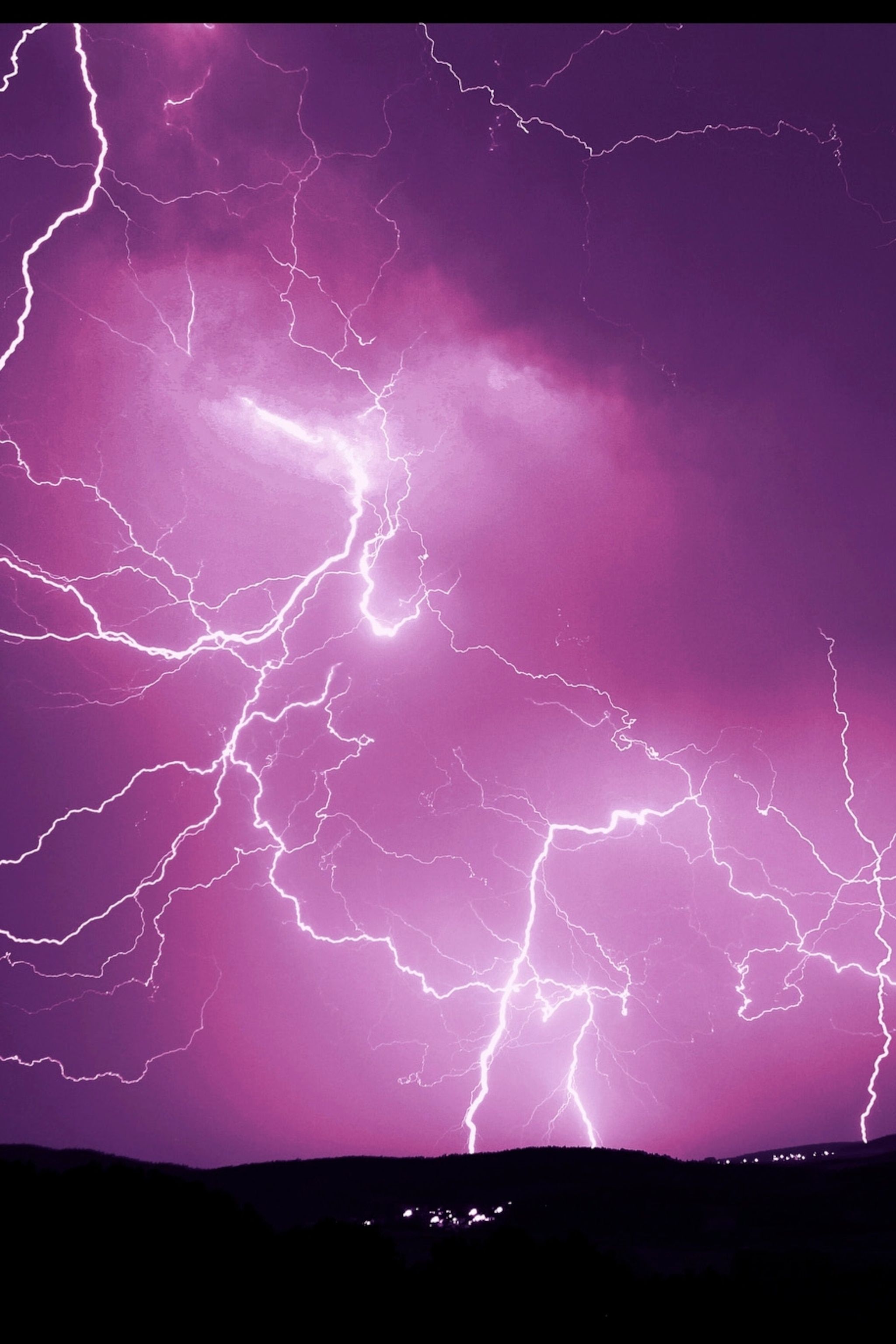 A purple sky with lightning bolts in it. - Storm
