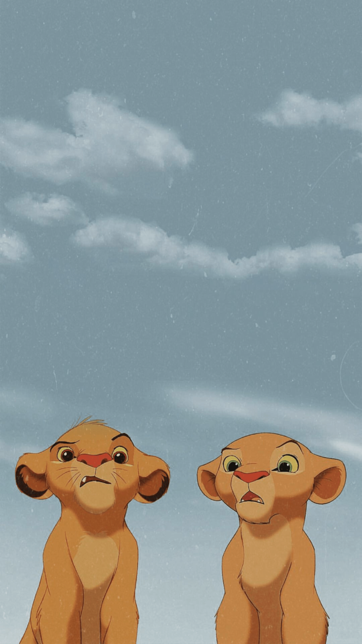 A couple of lion cubs are standing together - The Lion King