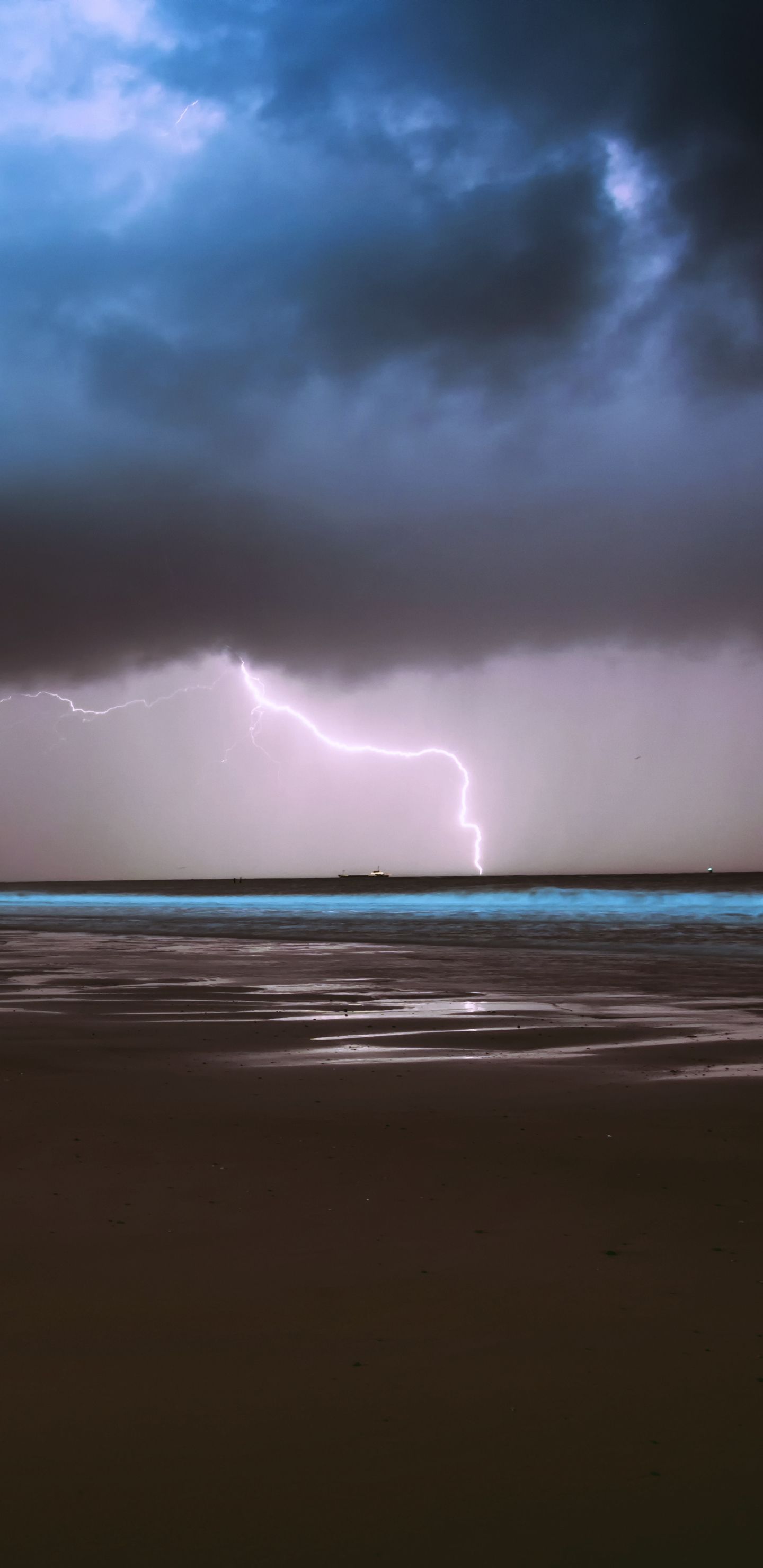 A bolt of lightning strikes the ocean during a storm. - Storm