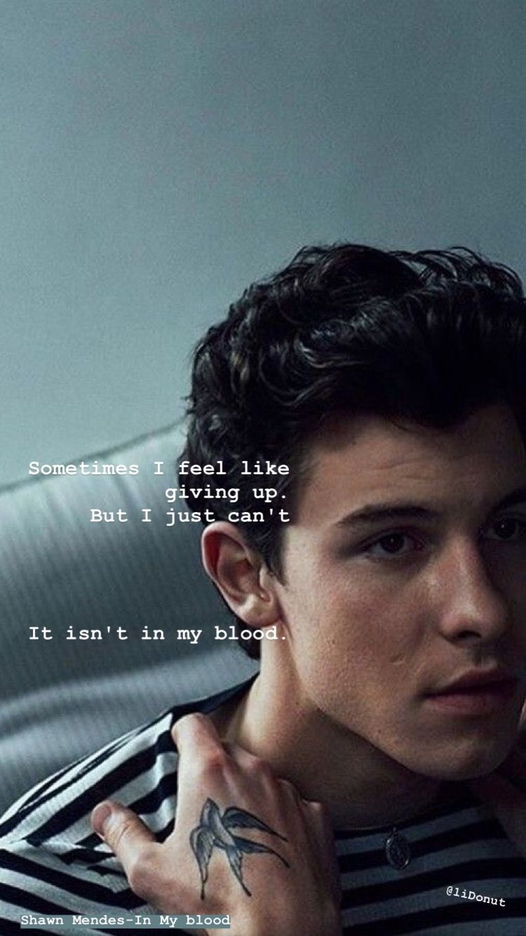 A man with tattoos and the words i'm not in love - Shawn Mendes