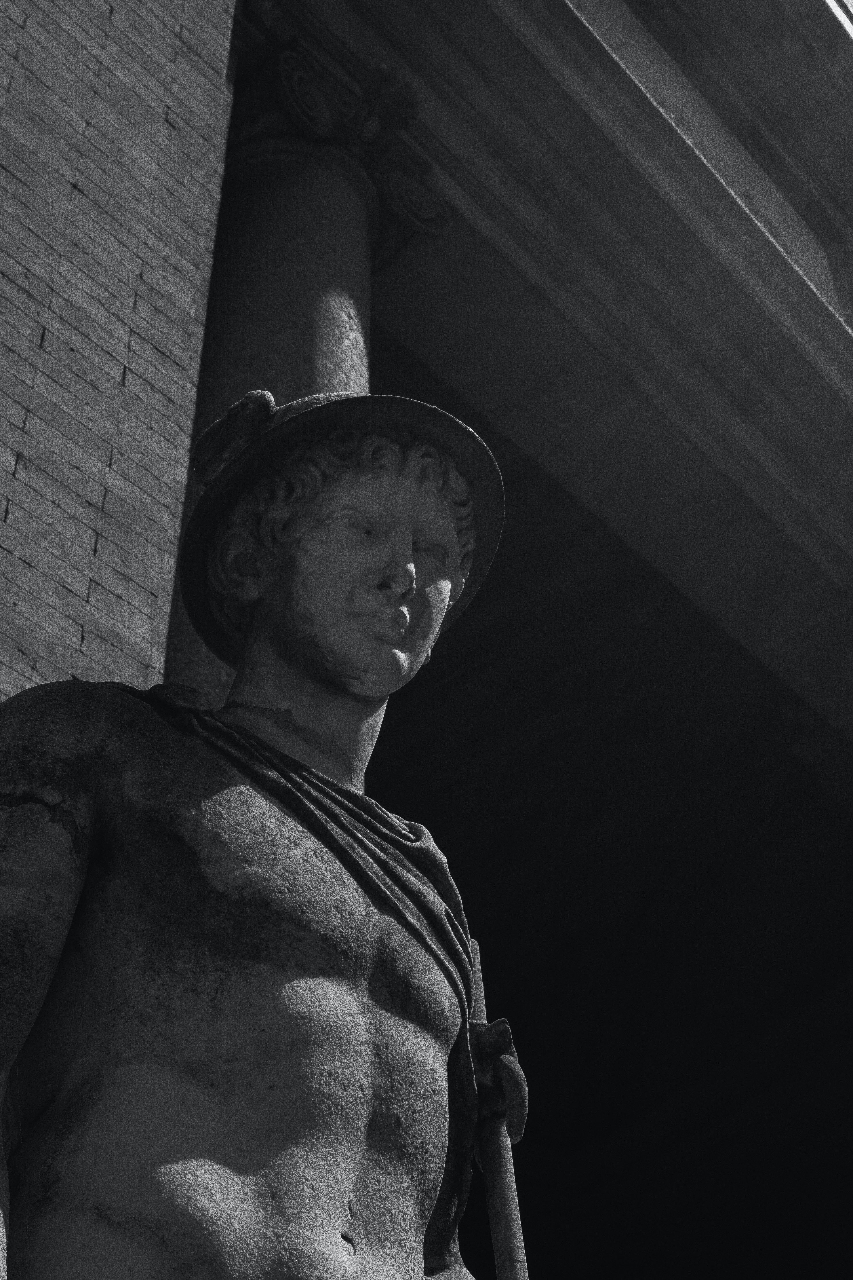 A statue of a Roman soldier stands in the sun. - Greek mythology