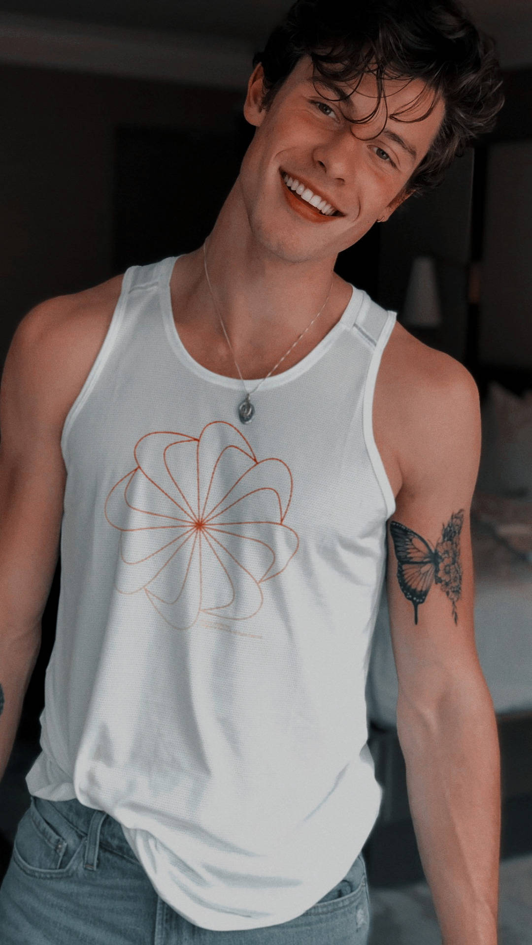 A man in jeans and white tank top - Shawn Mendes