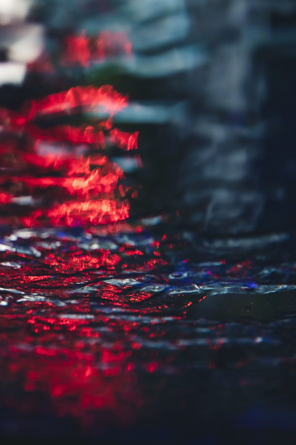 A river with red lights reflecting on it - Blurry