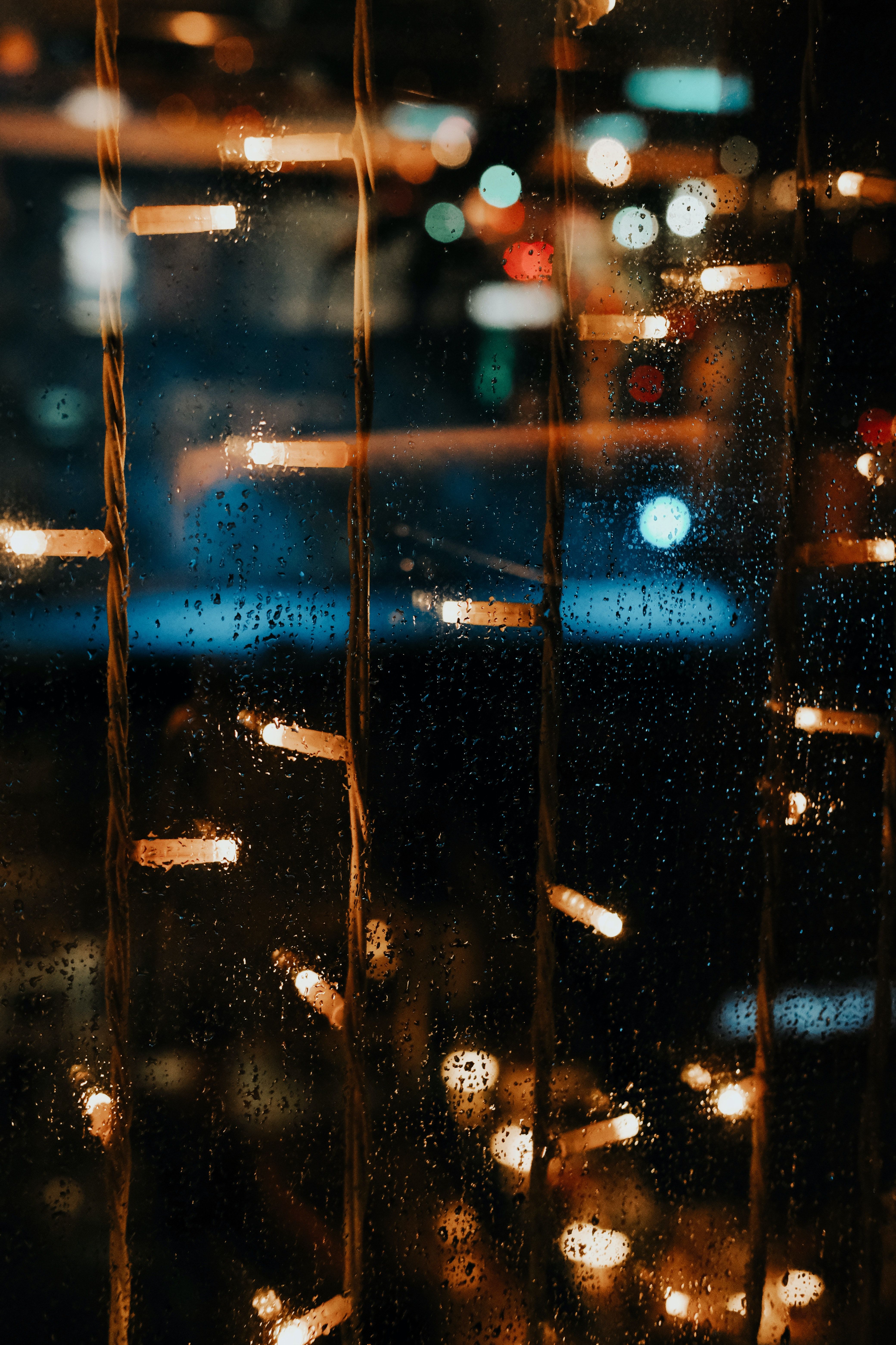 Blurry City Lights From Behind a Rainy Window at Night · Free