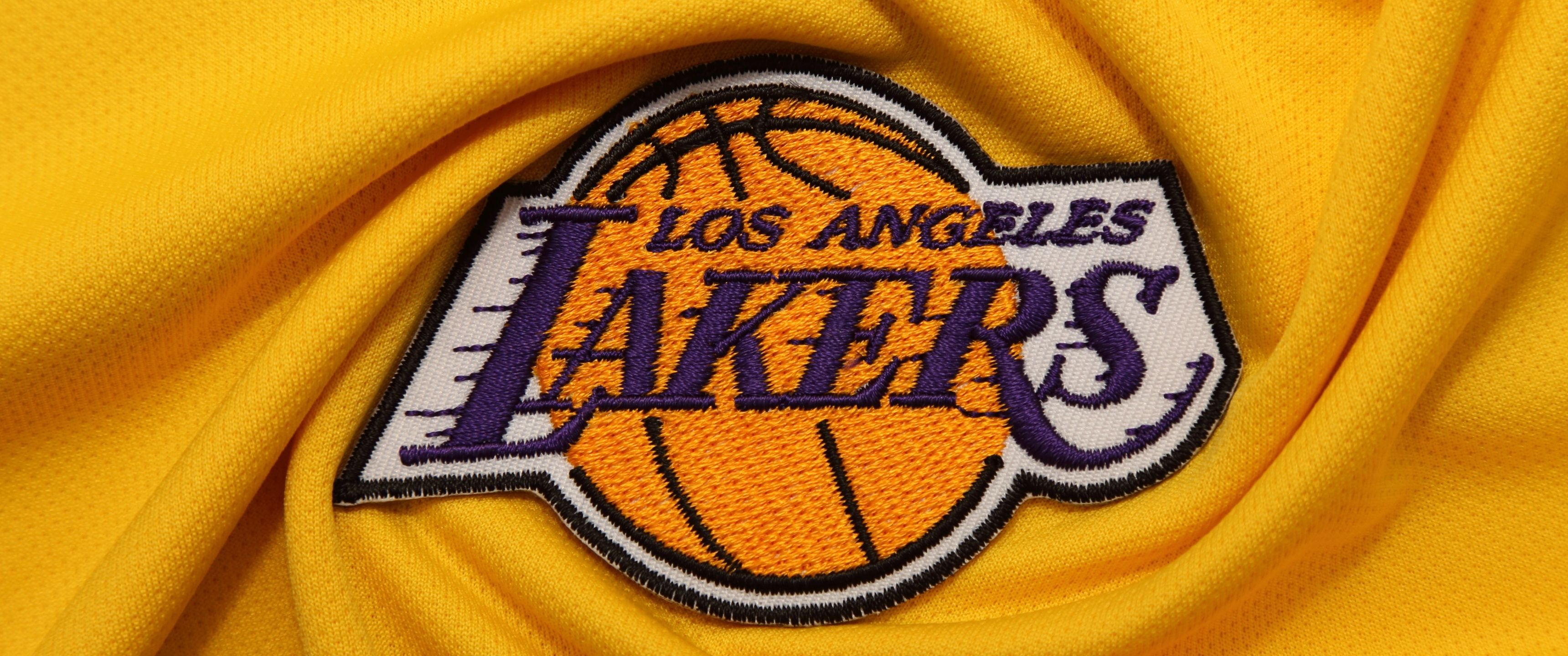 The Los Angeles Lakers logo on a yellow jersey. - Los Angeles Lakers