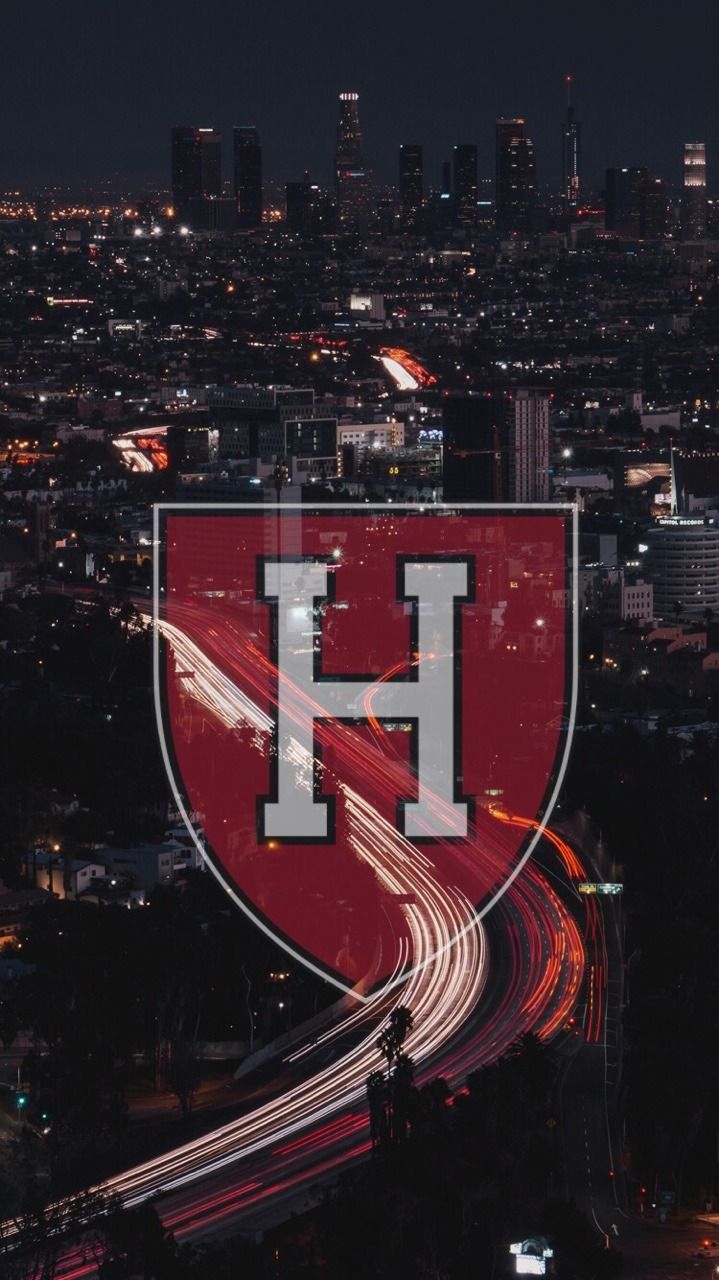 A phone wallpaper of the Harvard logo with a city in the background - Harvard
