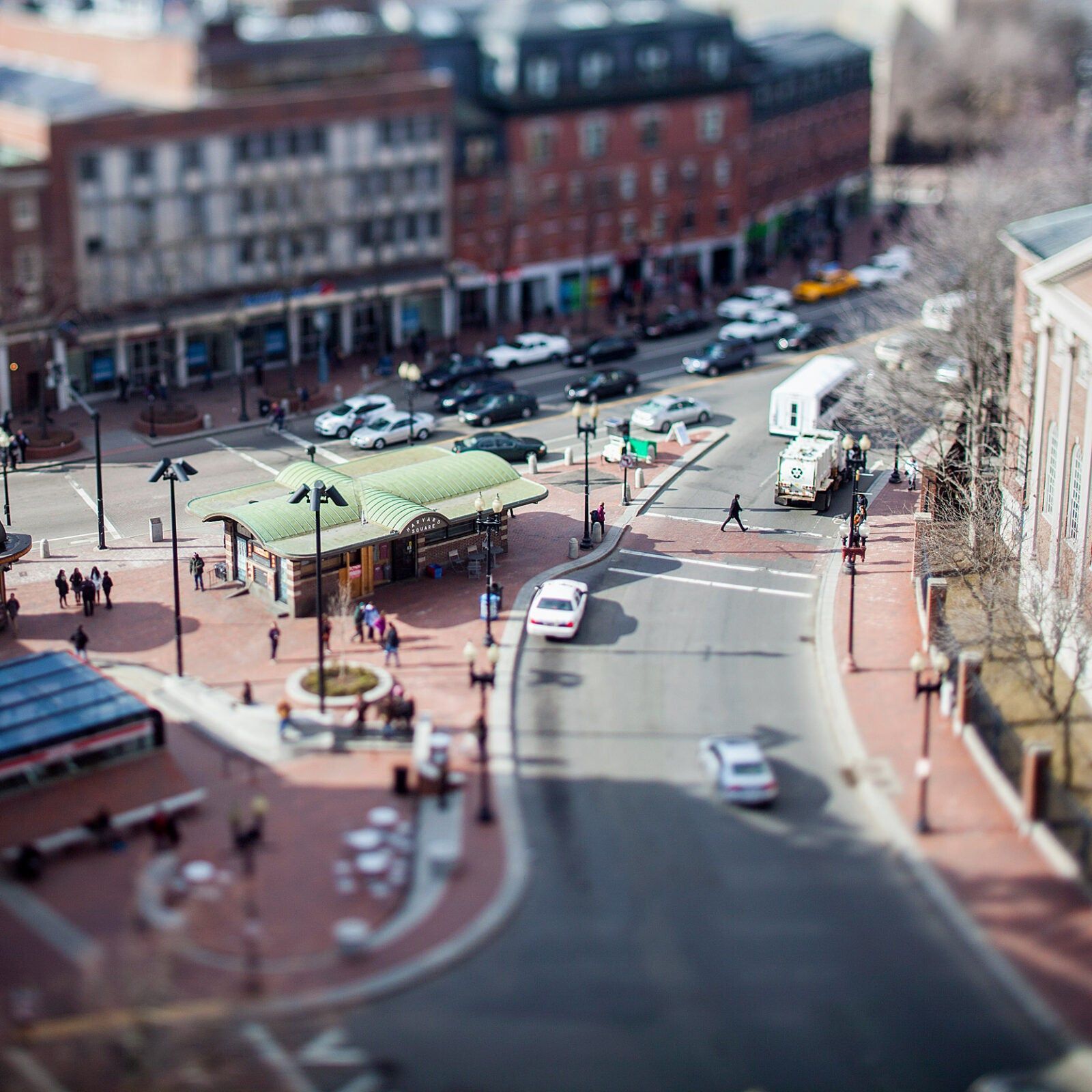 A city street with cars, trucks, and pedestrians - Harvard