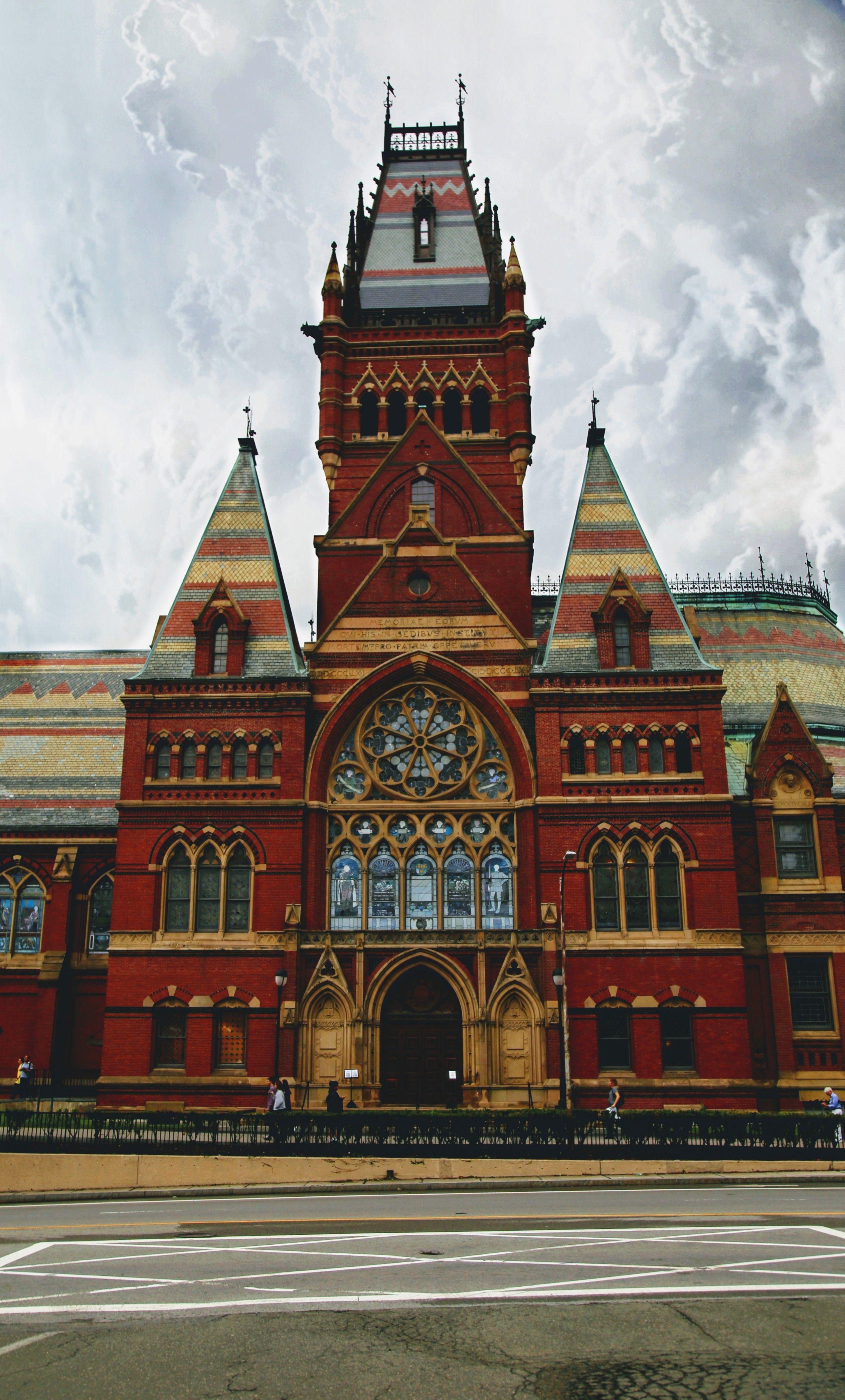 A red brick building with a tall clock tower. - Harvard