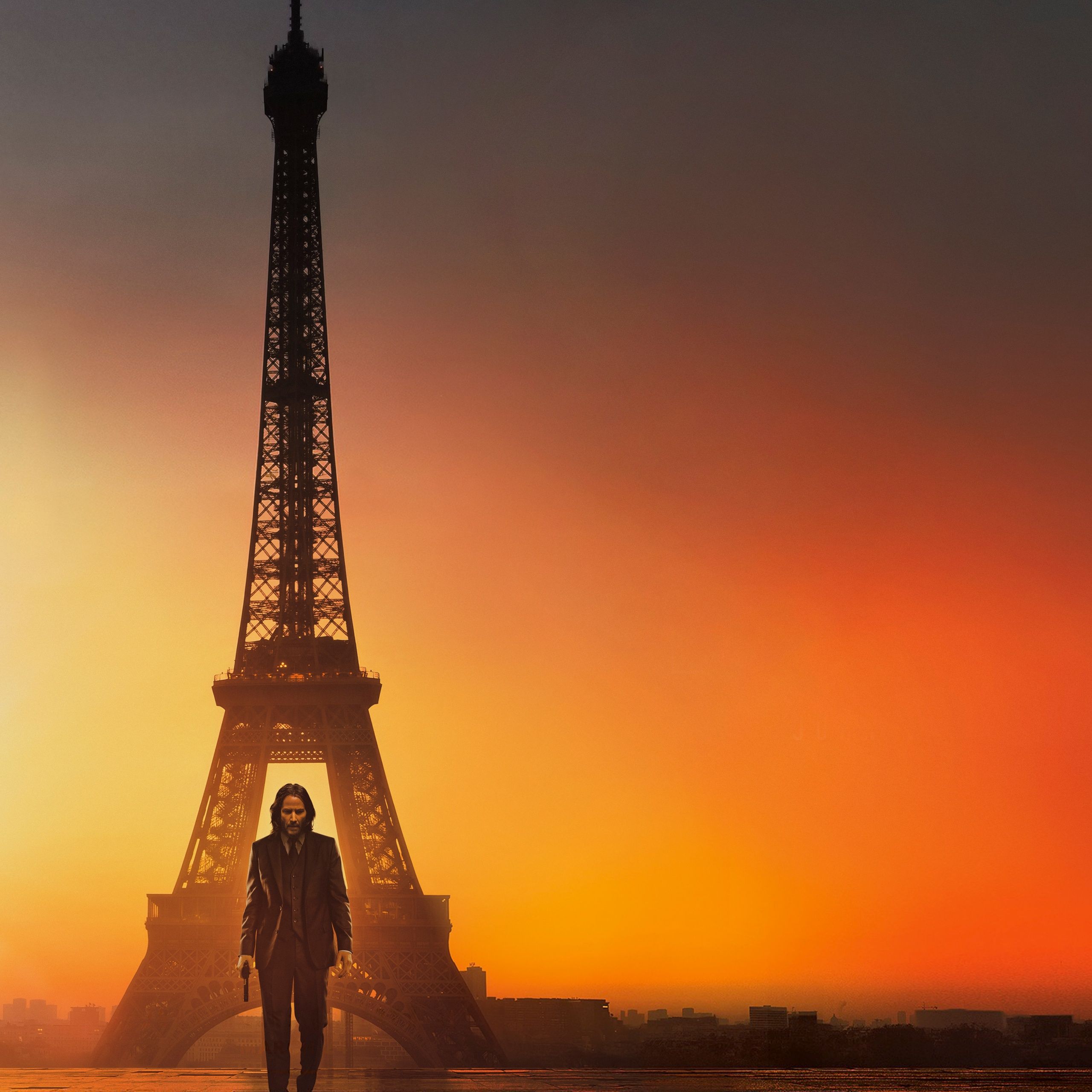 A man walking in front of the Eiffel Tower at sunset - John Wick