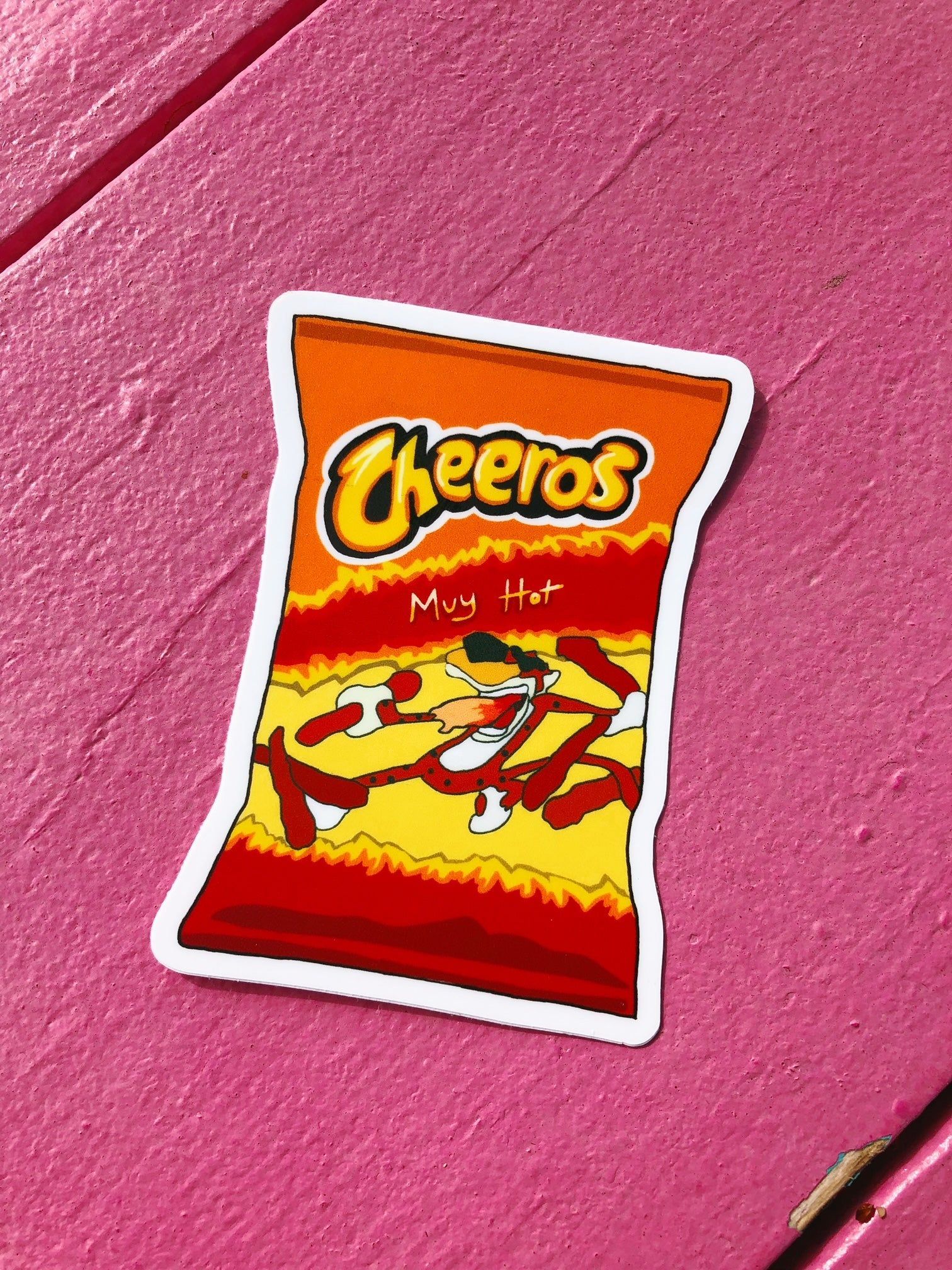 A sticker of a bag of Cheetos on a pink background - Cheetos