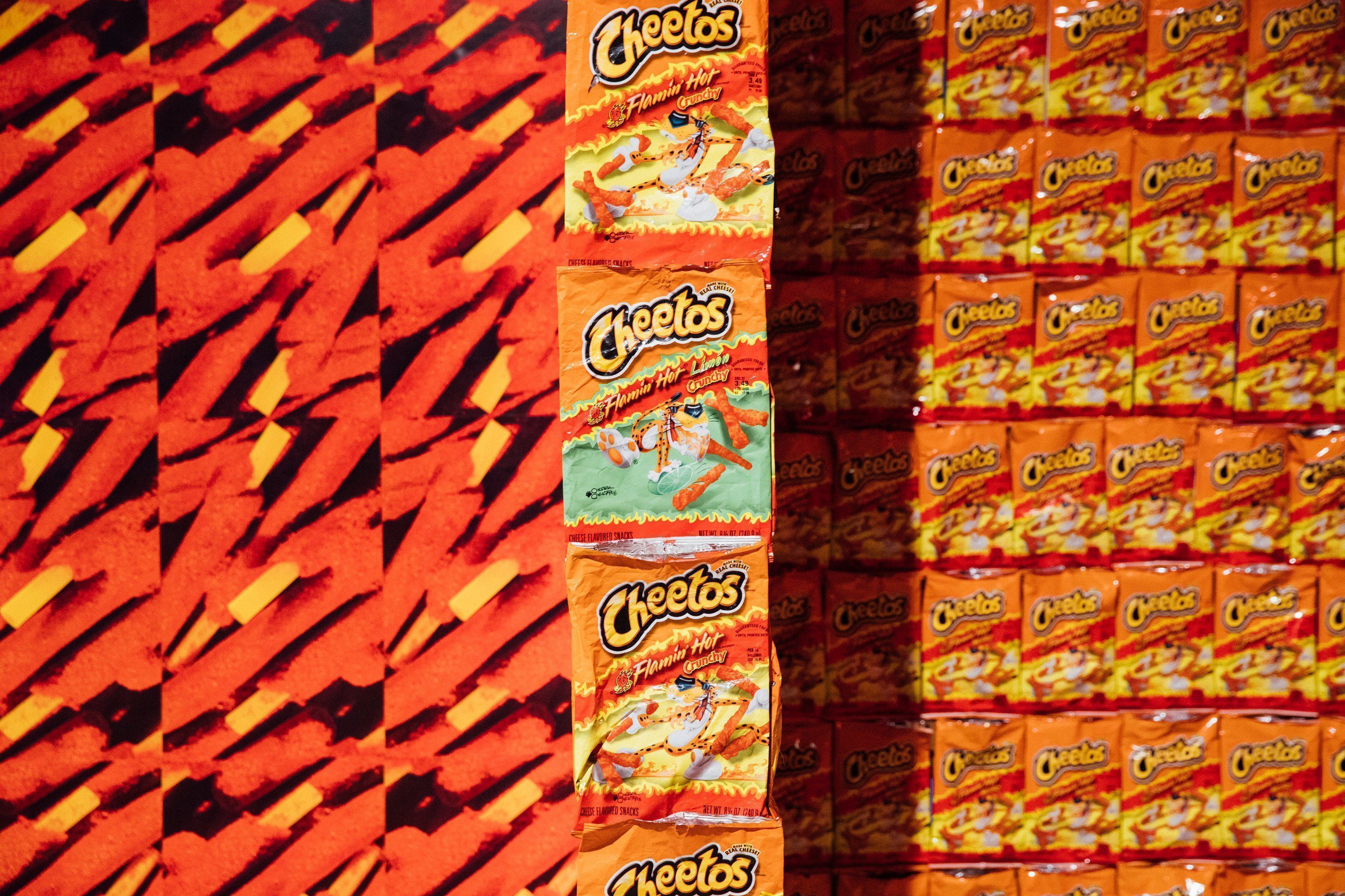 Cheetos snack bags are stacked on top of each other. - Cheetos
