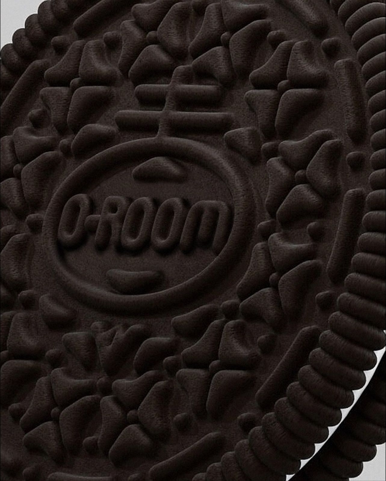 Close up of the embossed logo on the bottom of the Groom dog toy. - Oreo