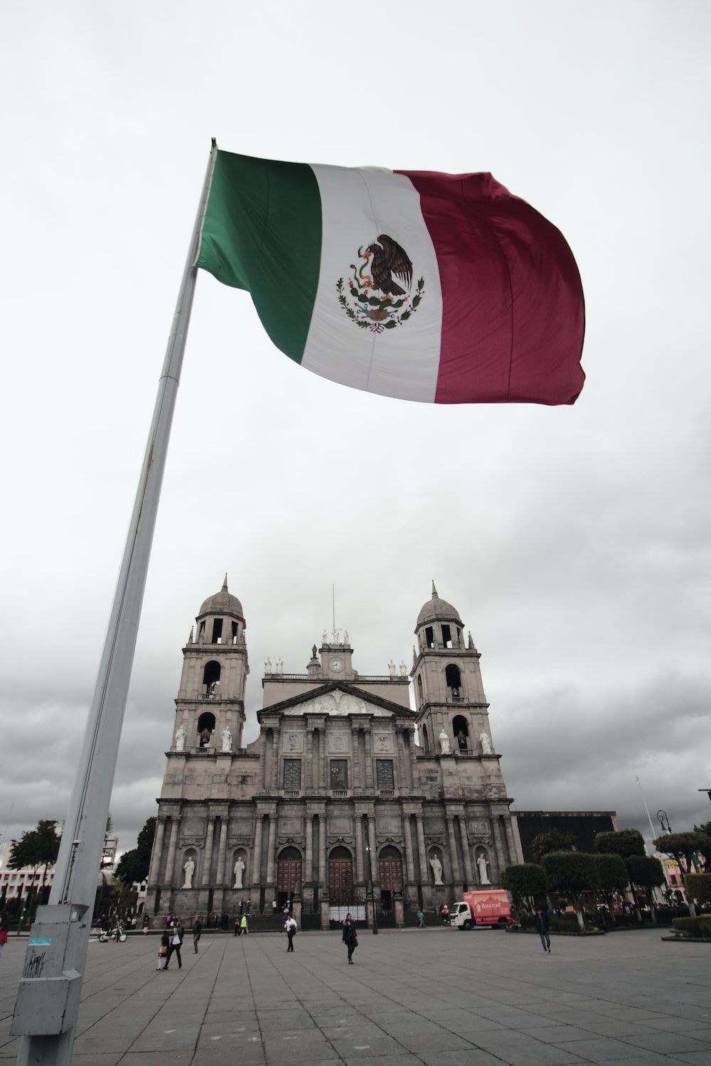 Mexican flag flying in front of a church - Mexico