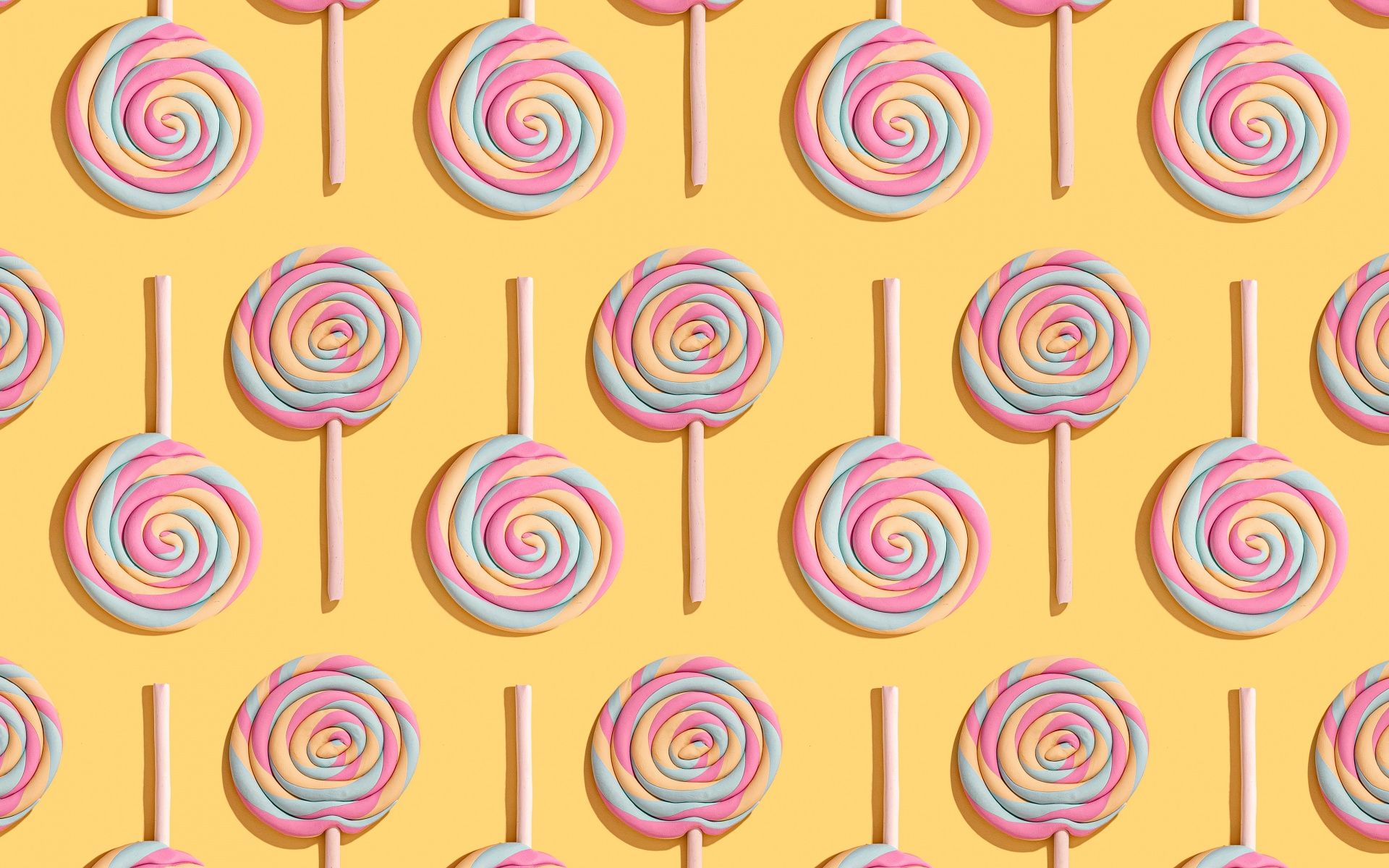 A pattern of lollipops on a yellow background - Pattern