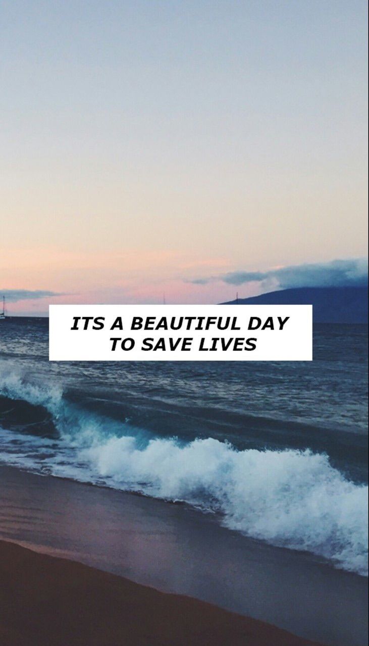 A beach with waves and the words it's beautiful day to save lives - Grey's Anatomy