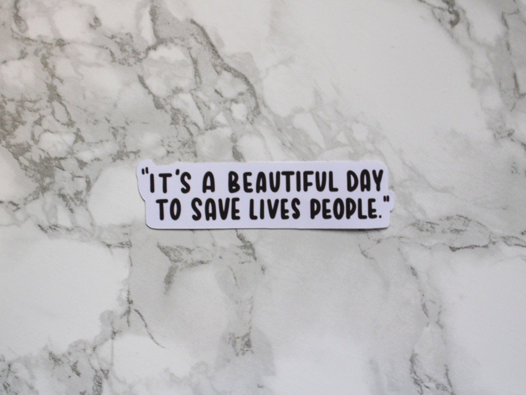 A sticker on the counter that says it's beautiful day to save people - Grey's Anatomy