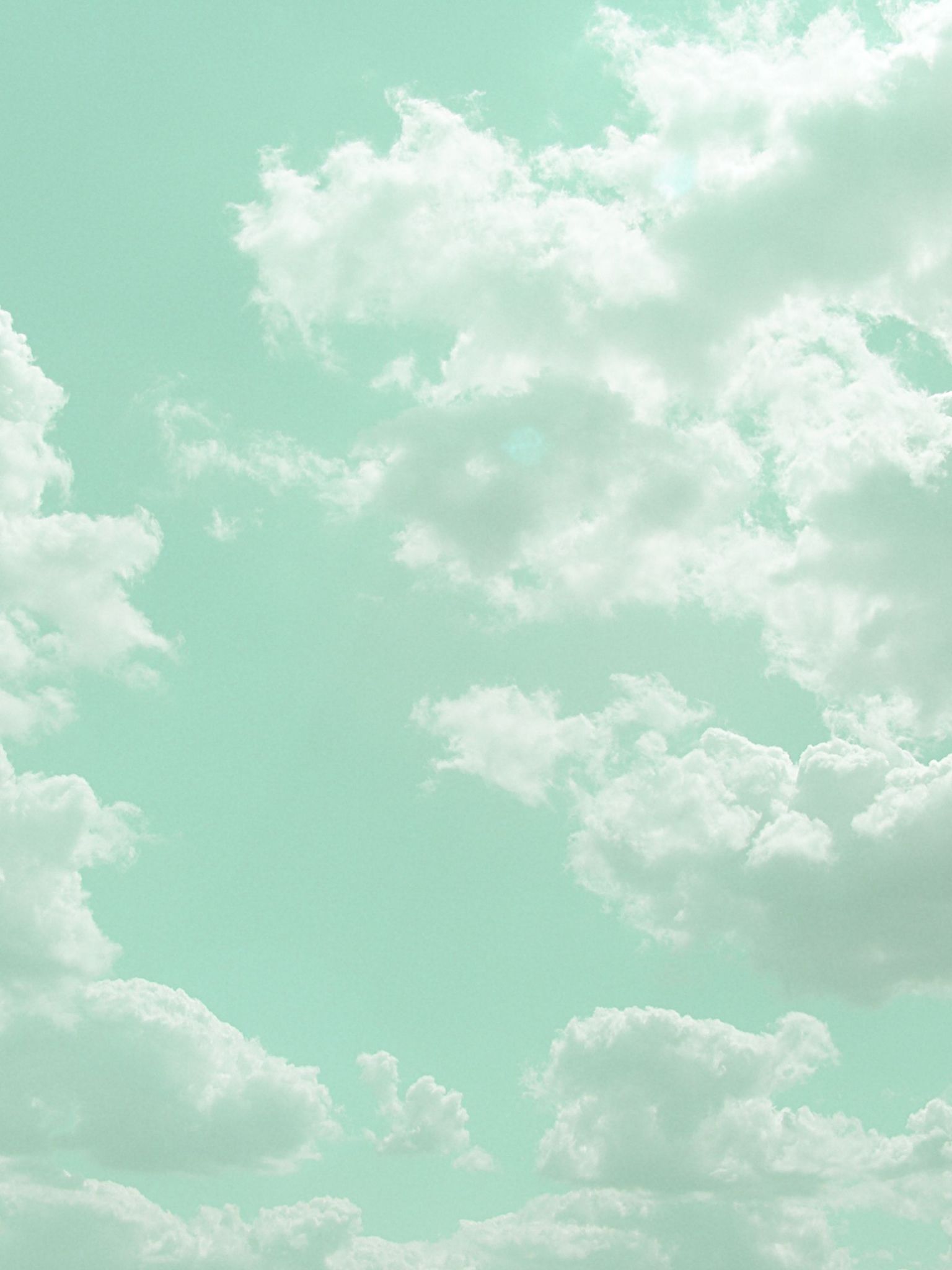 A photo of a blue sky with white clouds. - Soft green