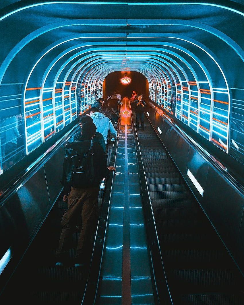 People walking down a neon-lit escalator - Lo fi