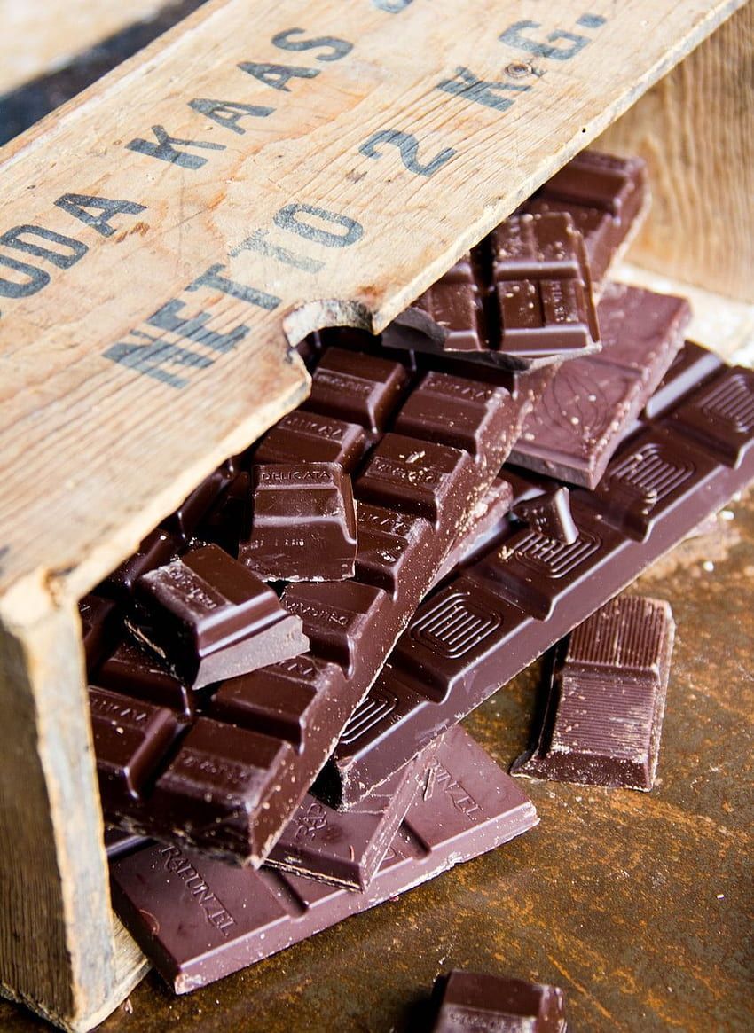 A wooden box of chocolate bars on a wooden table. - Chocolate