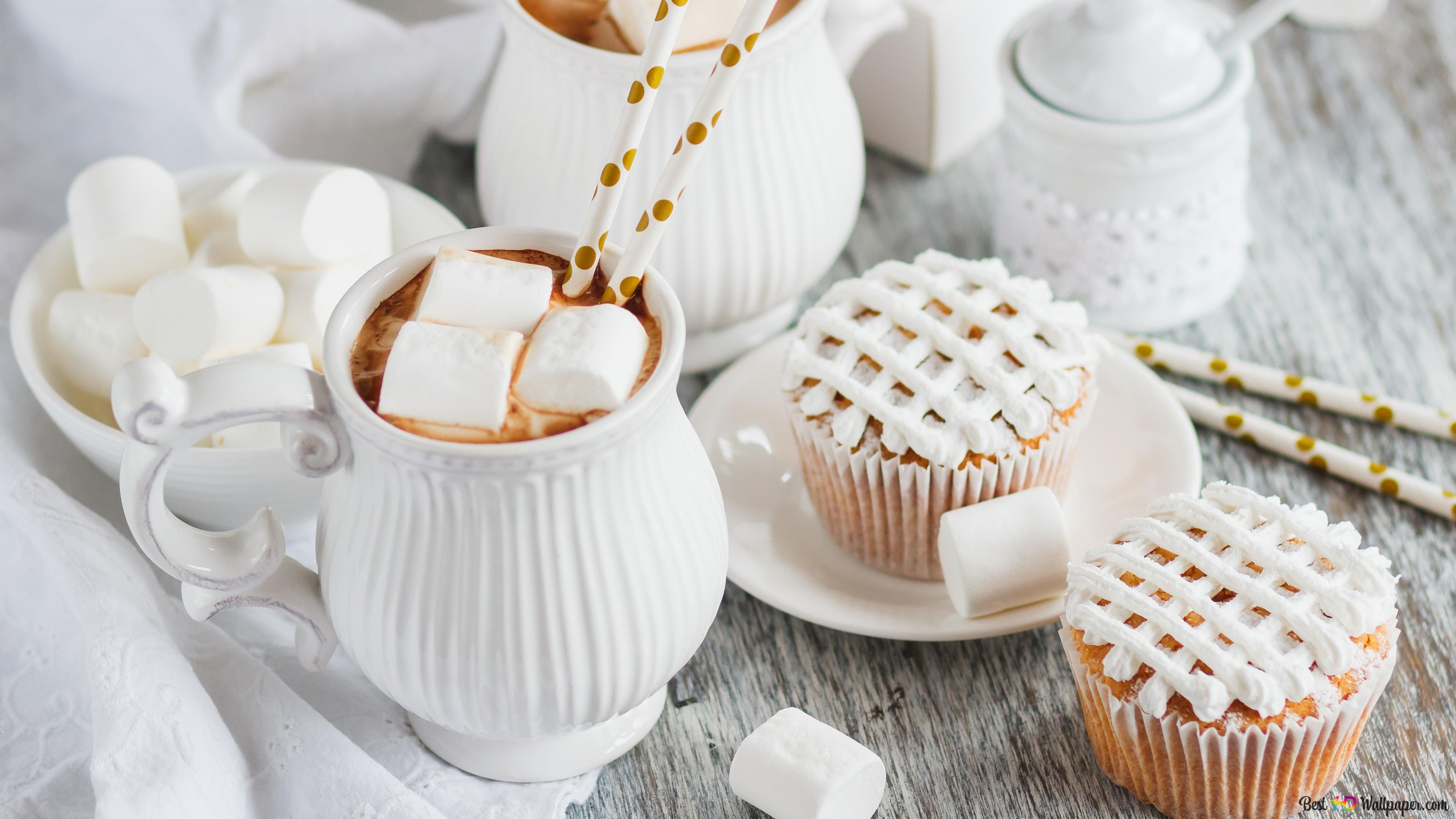 A cup of hot chocolate with marshmallows, a cupcake and a teapot - Marshmallows