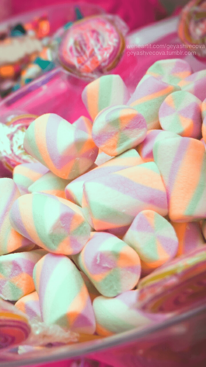 A pink and green candy in a pink bowl. - Marshmallows