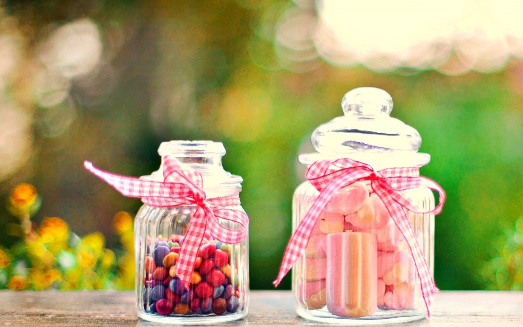 Two jars with candy and candles in them - Marshmallows