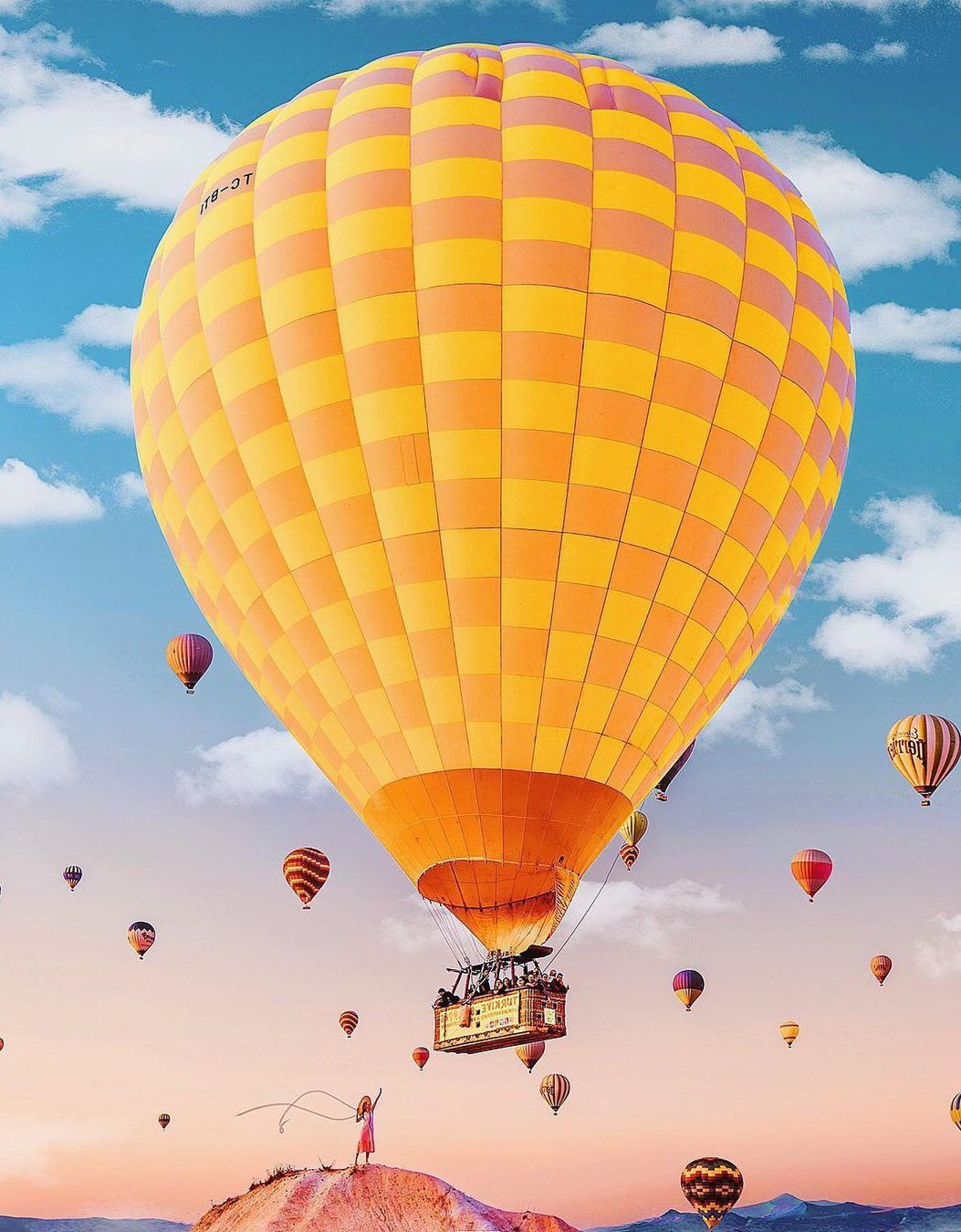 A hot air balloon flying over the desert - Yellow iphone, yellow