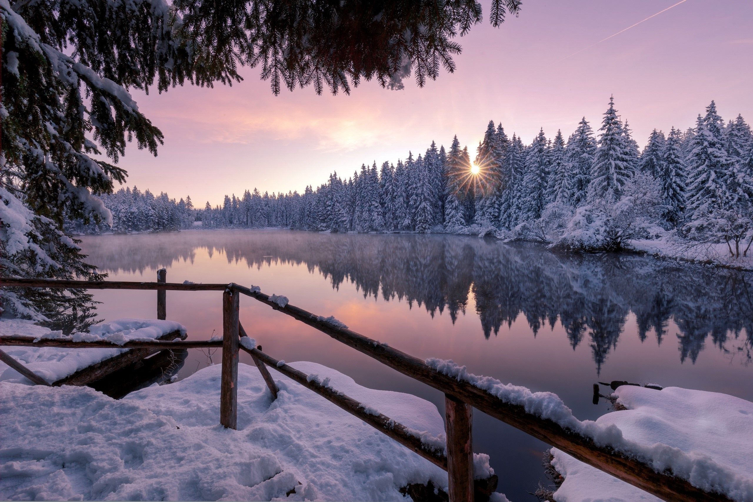 A beautiful winter sunset over a snow covered lake - Winter