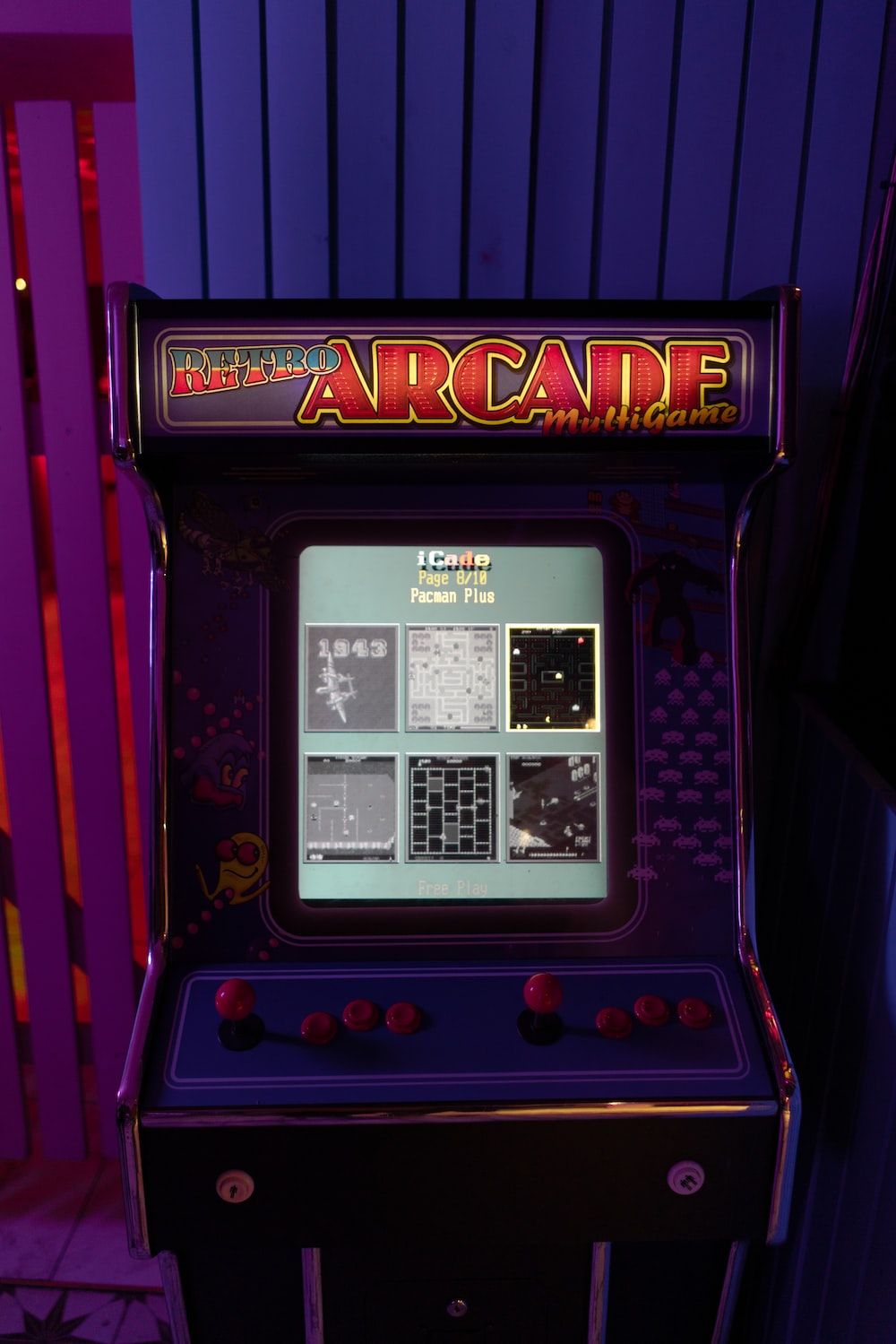 A bar top arcade machine with a purple neon light on top. - Arcade