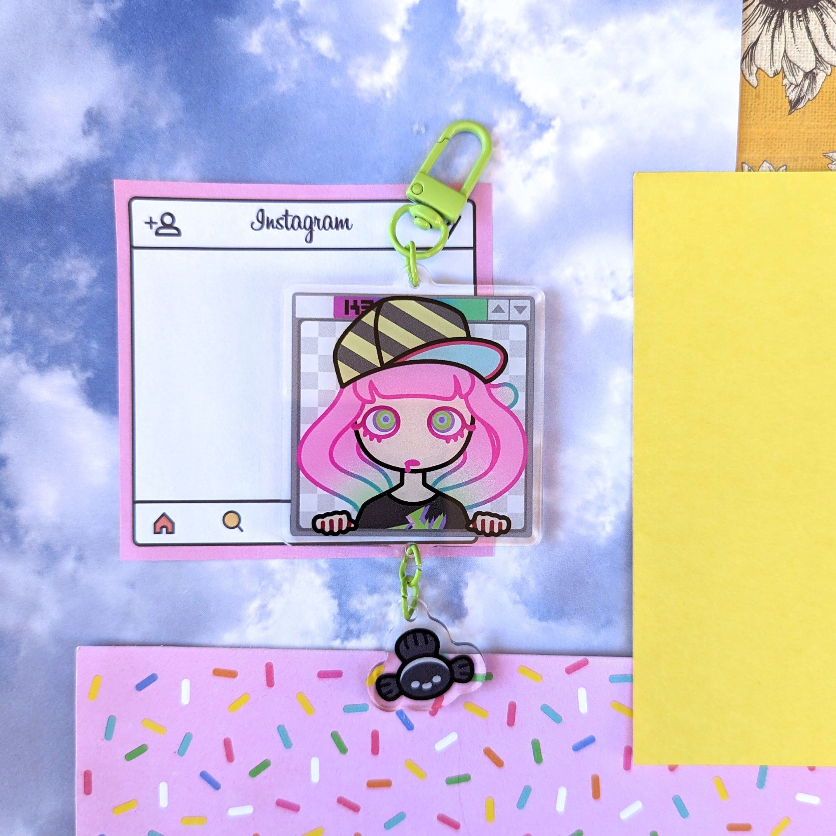 A keychain with a cartoon image of a girl with pink hair and a baseball cap. - Internetcore