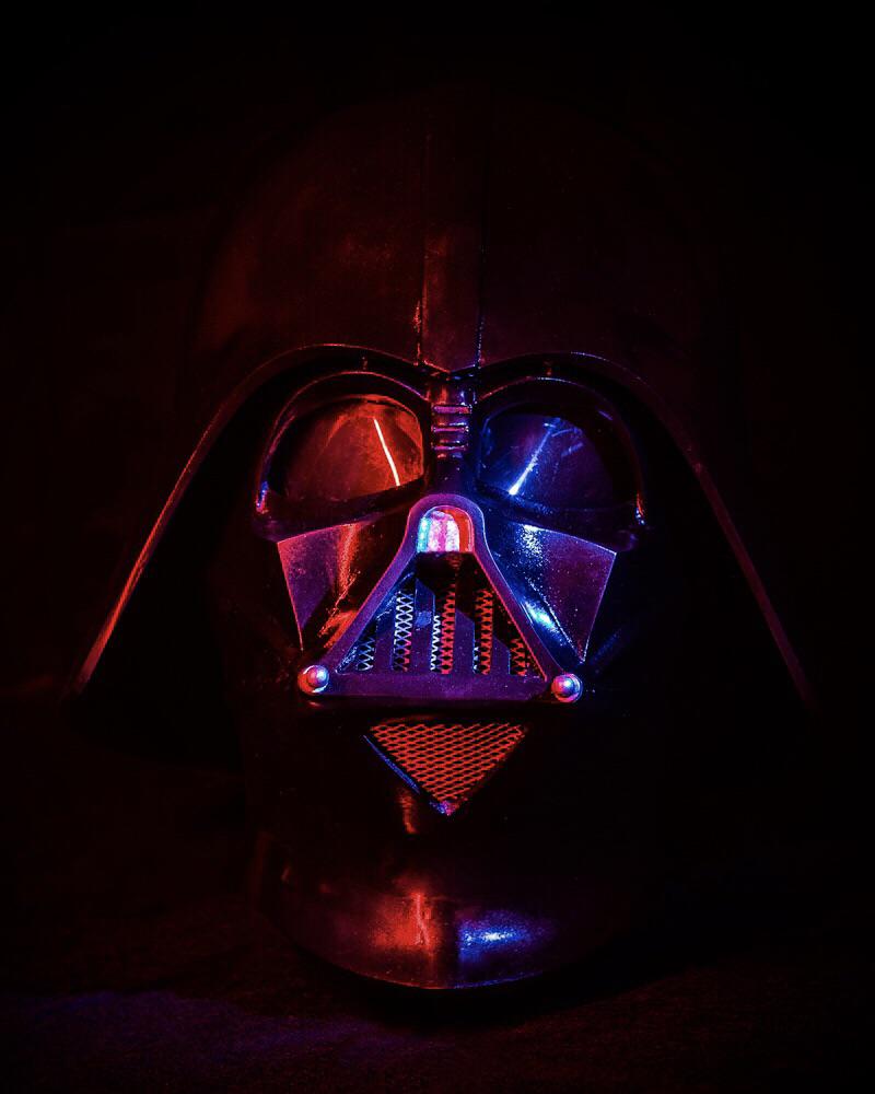 A darth vader helmet lit up in red and blue. - Darth Vader