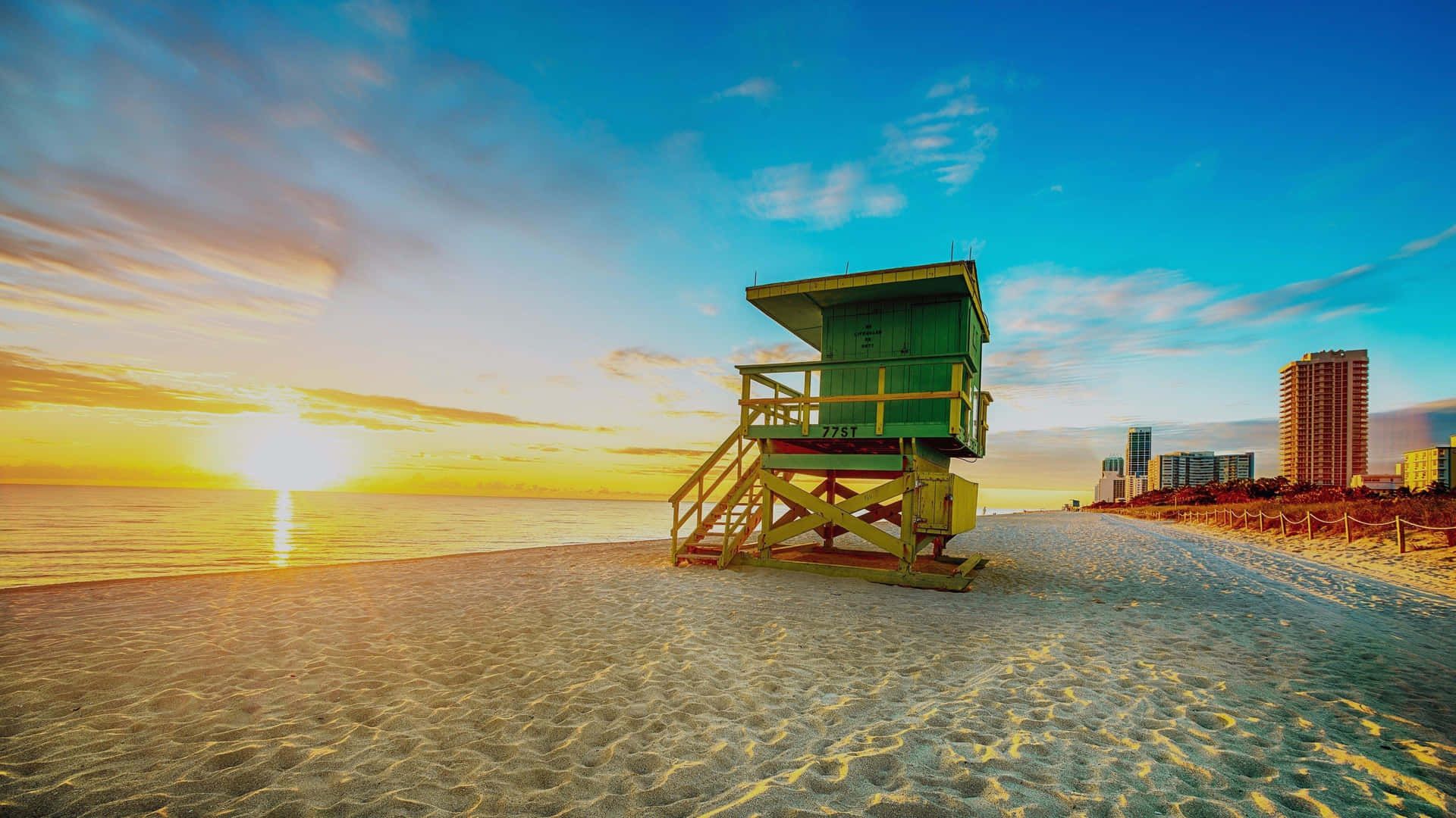 A lifeguard tower on a beach at sunset - Miami