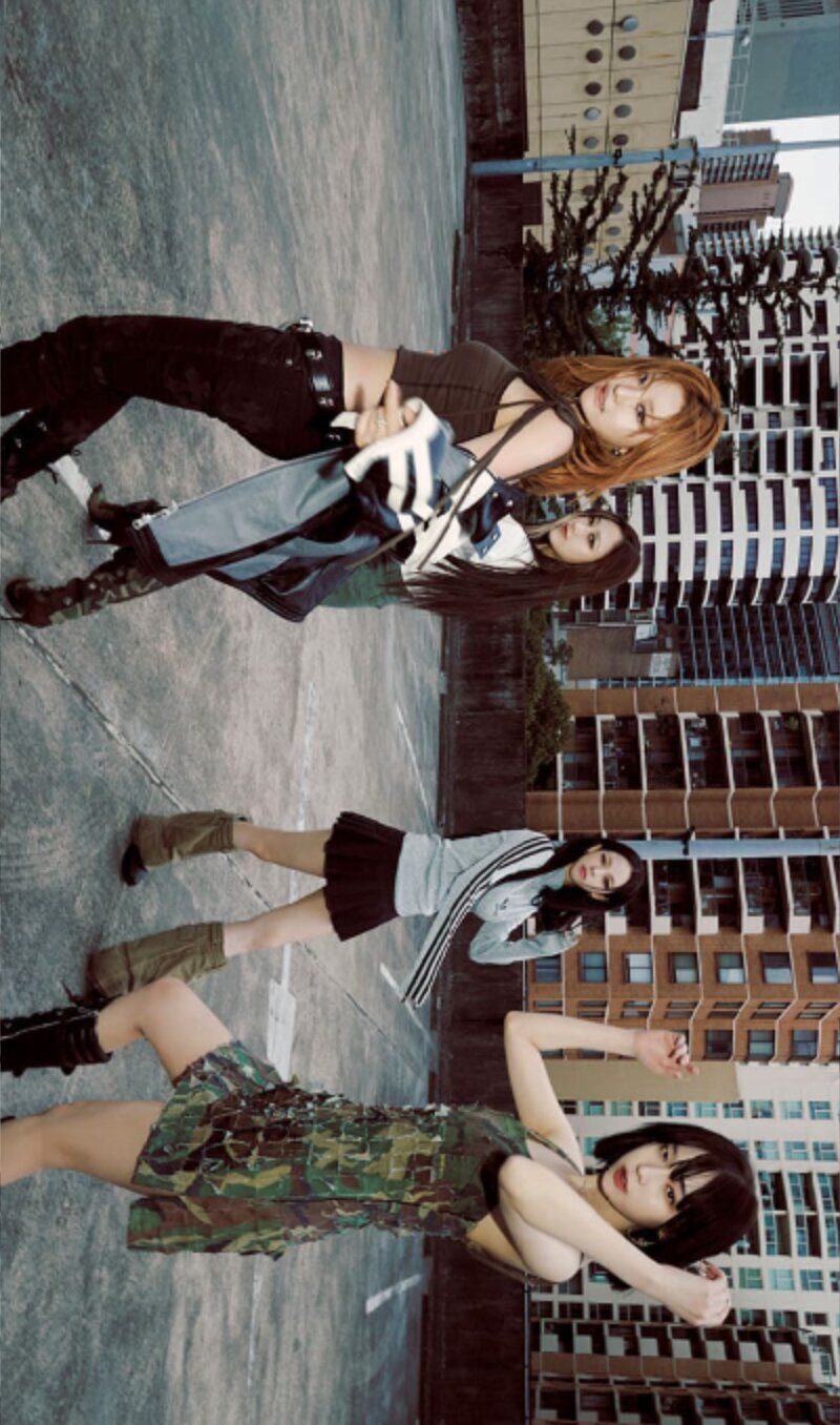 Three women in short shorts and knee high boots pose for a picture. - Aespa