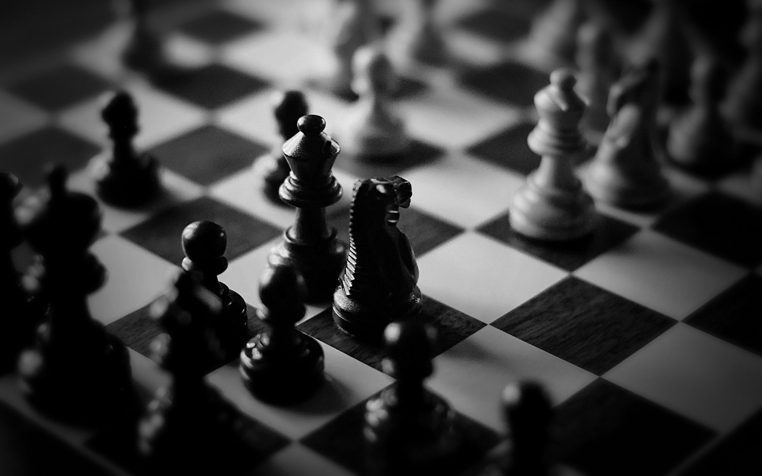 A black and white chess board with pieces - Chess