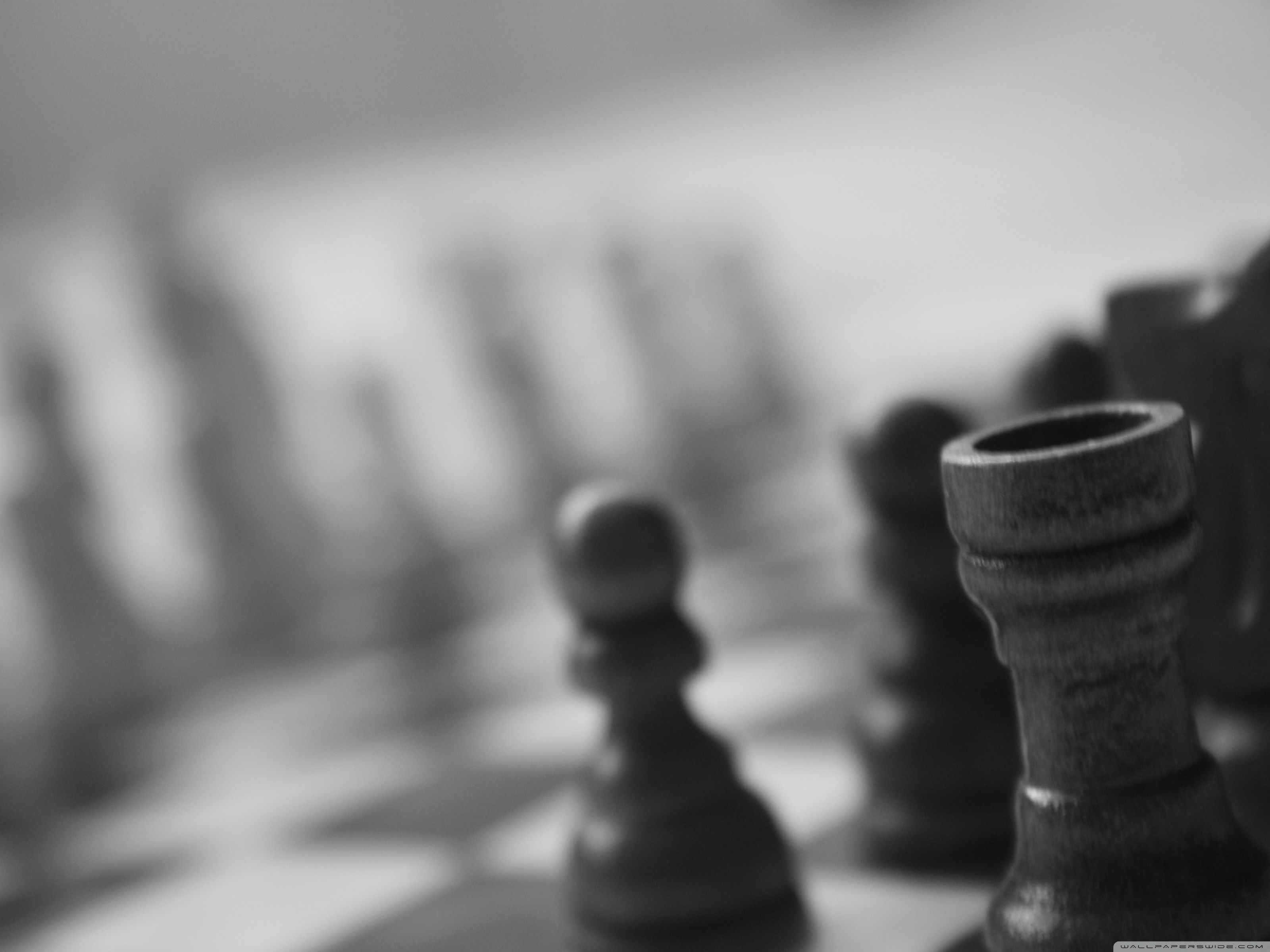 Black and white image of a chess board with a black pawn in the foreground. - Chess